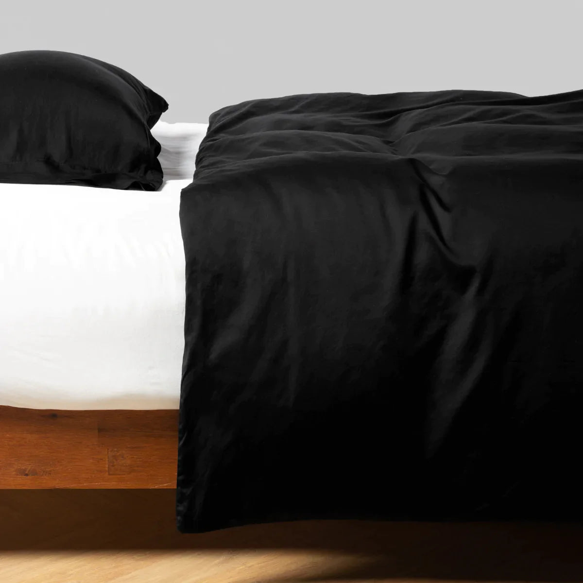 Corvino: duvet cover and matching sleeping pillow on white sheeting - side view.