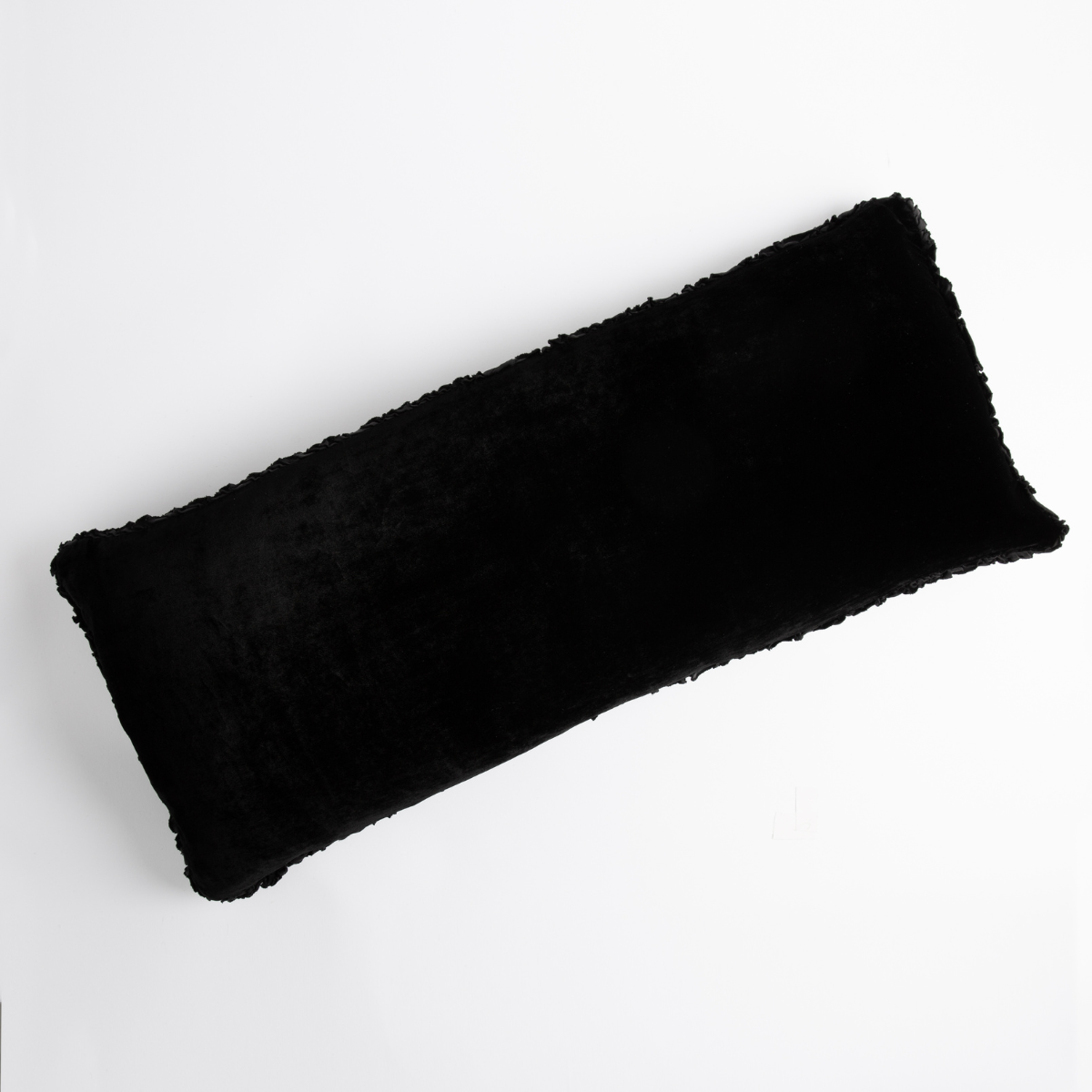 Corvino: pillow laid on a plain white background, petite ruffle detail on all four sides. 