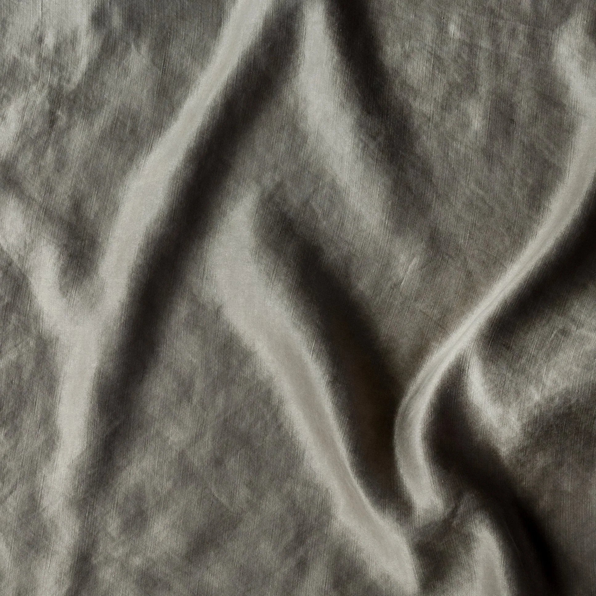 Moonlight: Close-up of silk charmeuse in moonlight, a saturated, cool, mid-dark grey tone. 