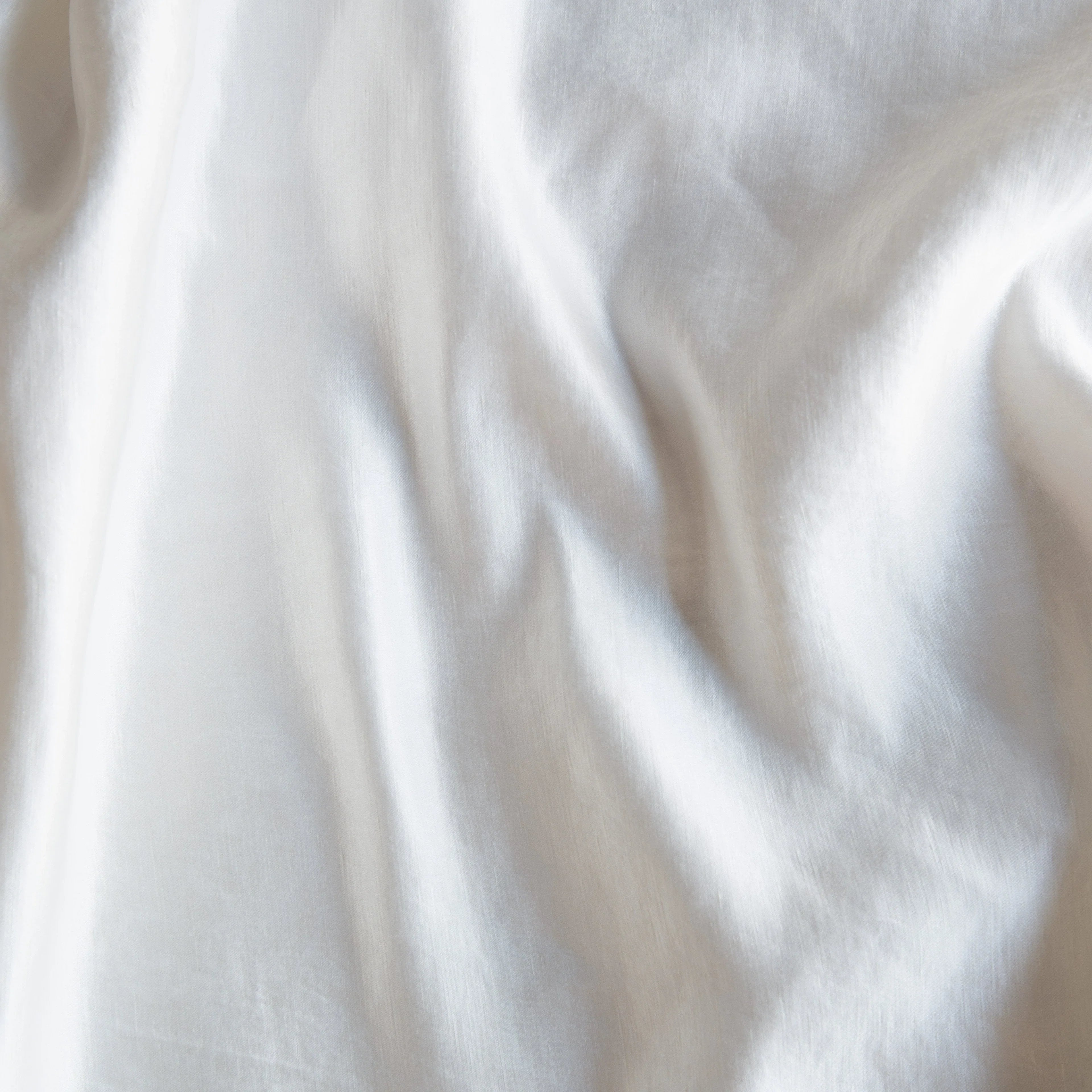 Winter White: Close-up of silk charmeuse in winter white, softer and warmer in tone than classic white.