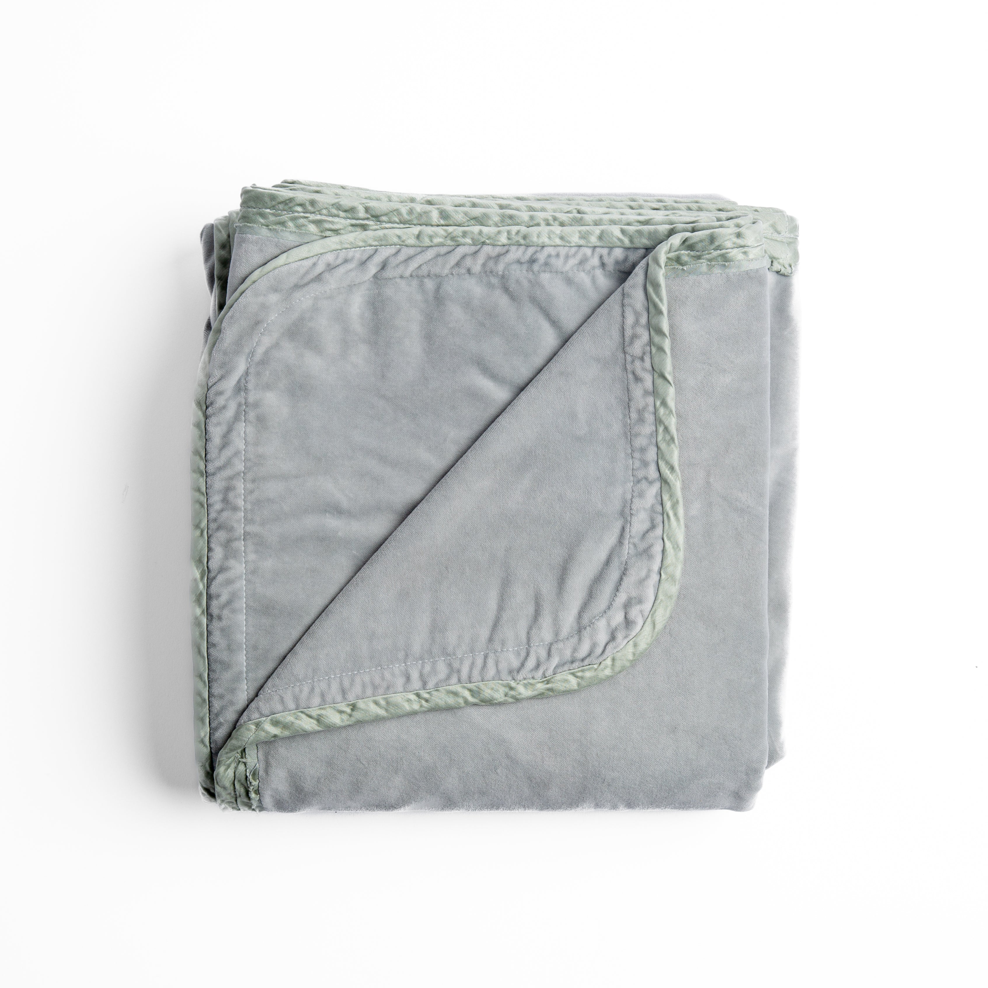 Mineral: overhead angle of the folded blanket with a corner pulled back to show the reverse and trim. 