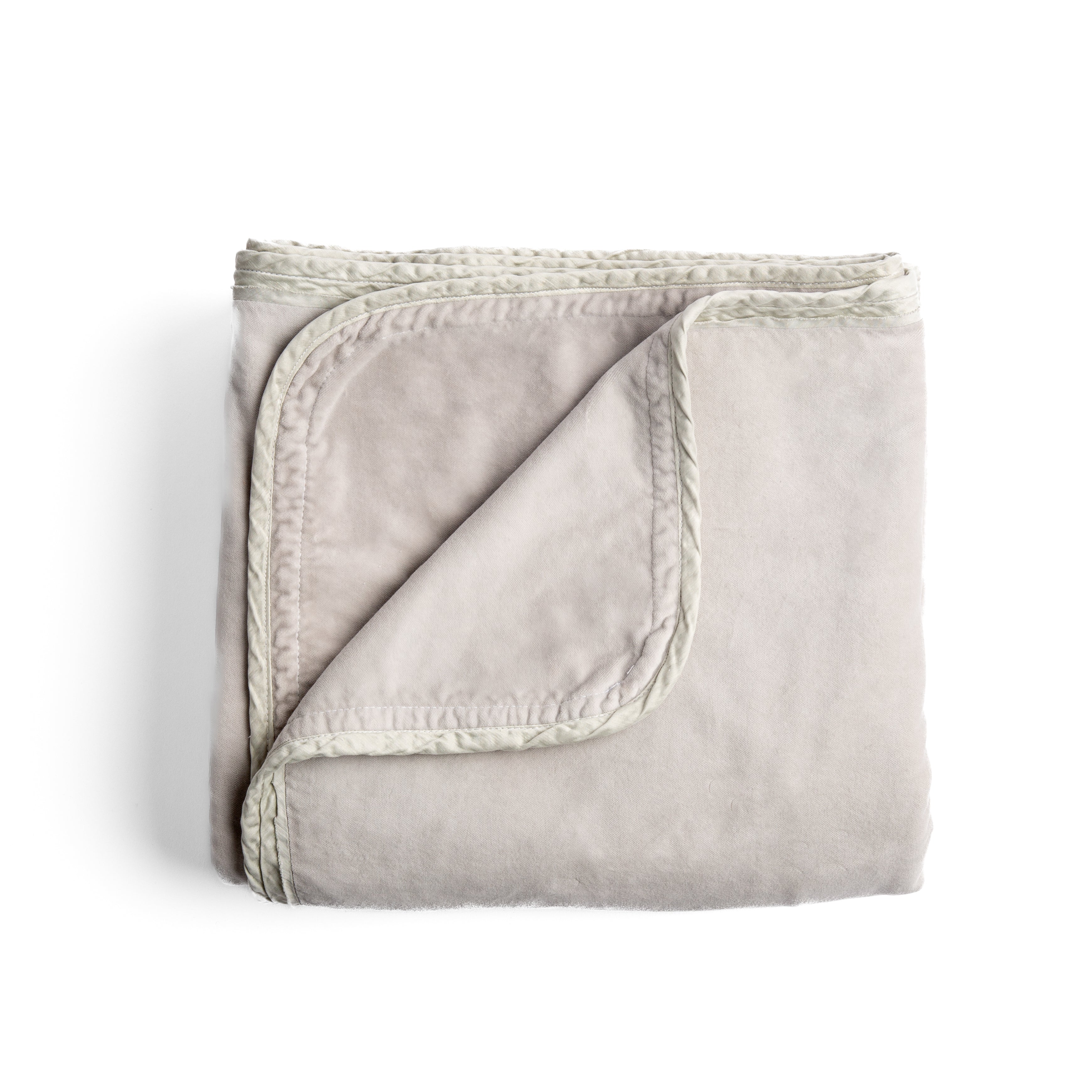 Sterling: overhead angle of the folded blanket with a corner pulled back to show the reverse and trim. 