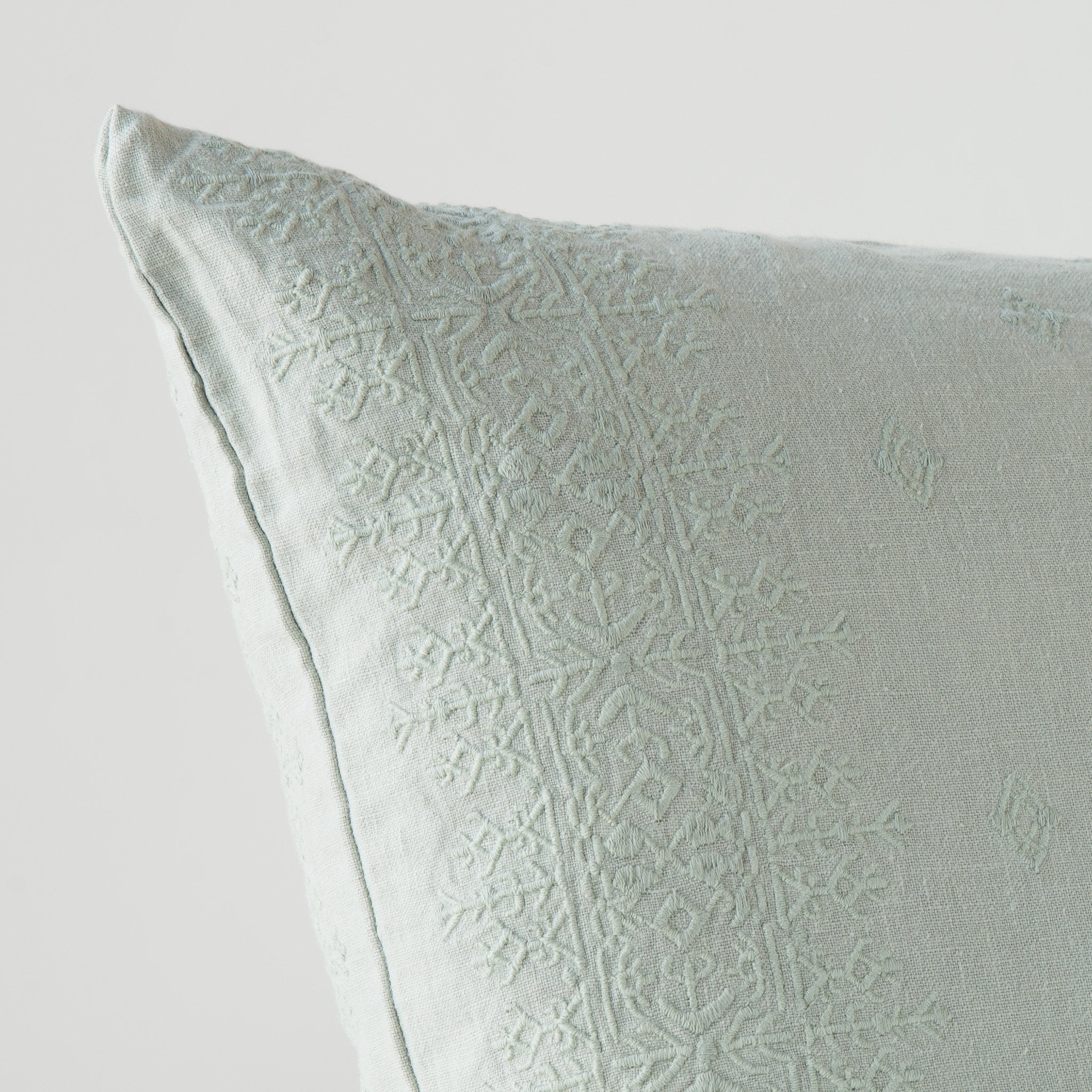 Eucalyptus: Close-up of pillow corner, showcasing the embroidery pattern detail.