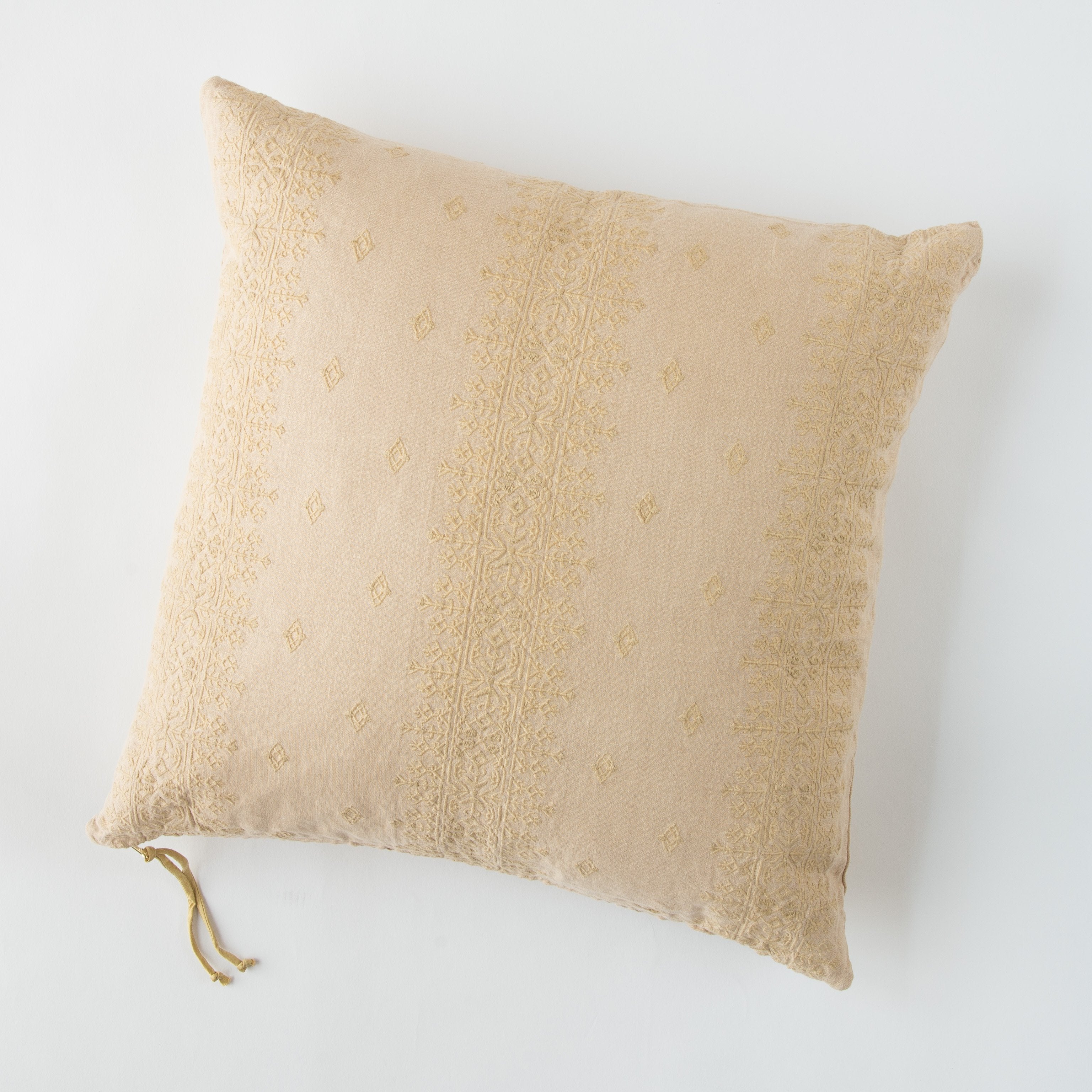 Honeycomb: Ines 24 by 24 pillow in honeycomb on a plain background - overhead view.