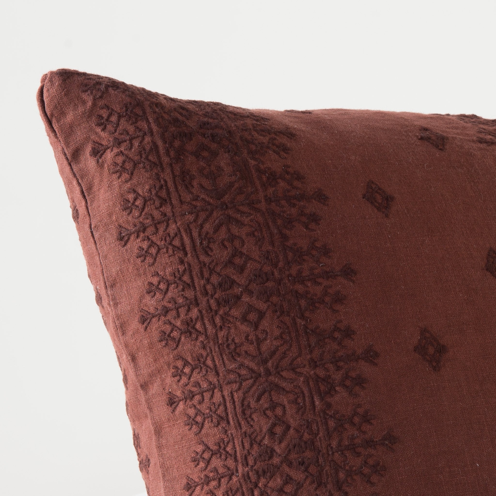 Mahogany: Close-up of pillow corner, showcasing the embroidery pattern detail.