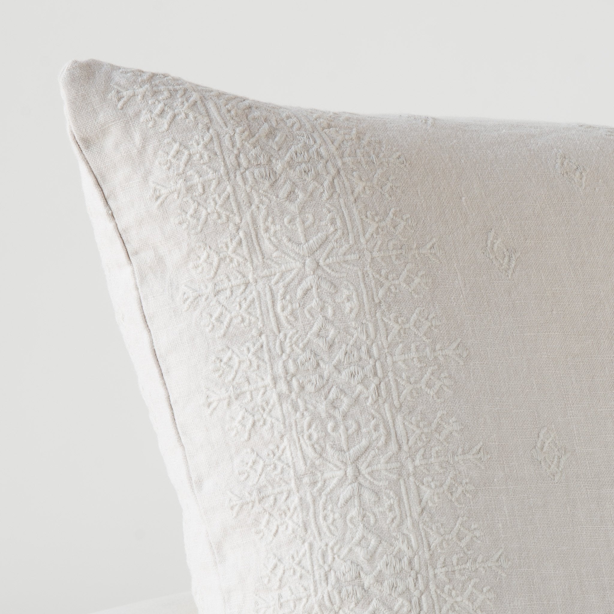 Sterling: Close-up of Ines throw pillow corner in sterling, showcasing the embroidery pattern detail.