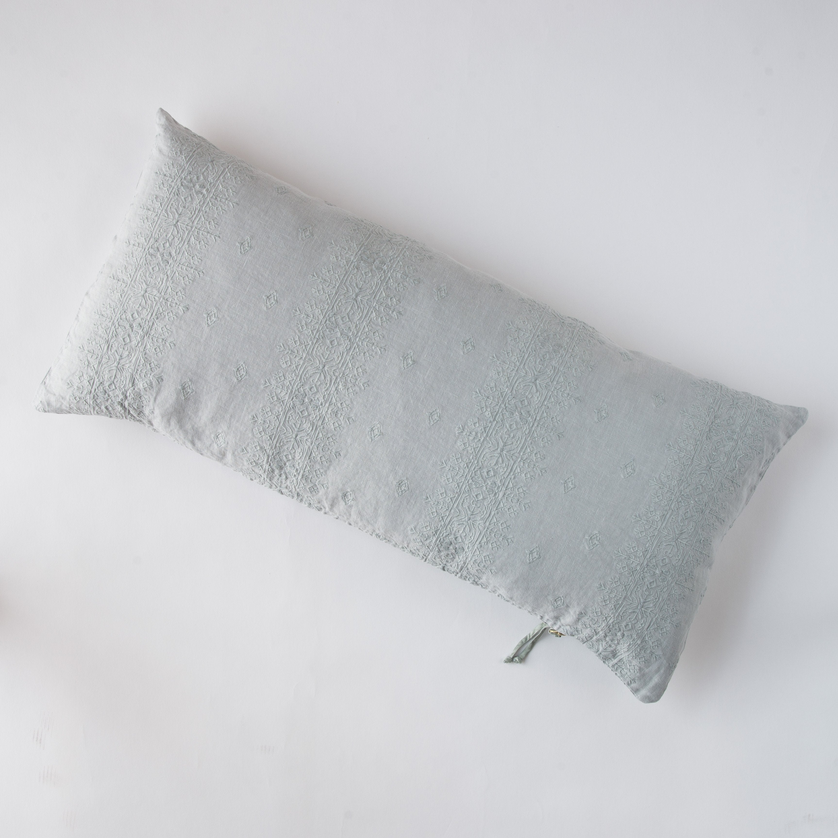 Mineral: embroidered midweight linen 16x36 pilow overhead on a white background. 