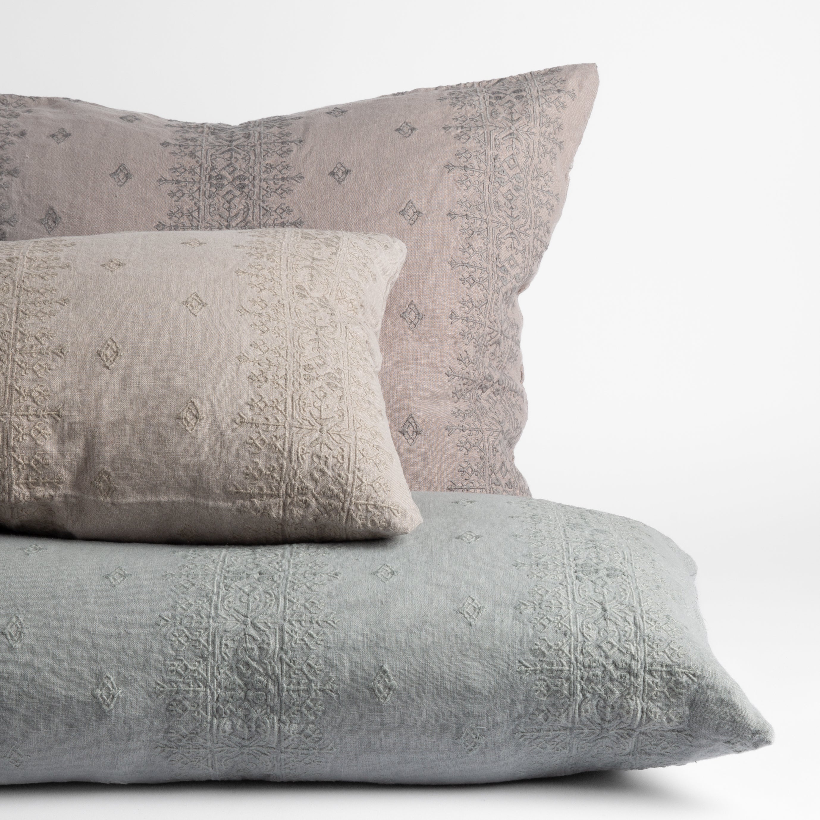 [allvariants]: embroidered midweight linen throw pillows straight on against a white background.