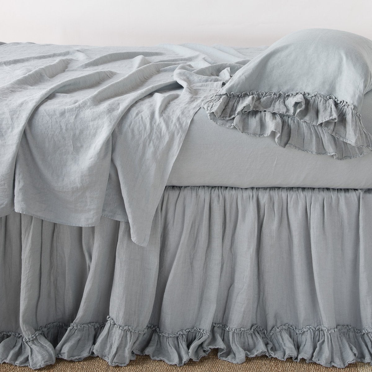 [allvariants]: Linen whisper bed skirt on a bed with monochromatic linen sheeting - mineral, side view.