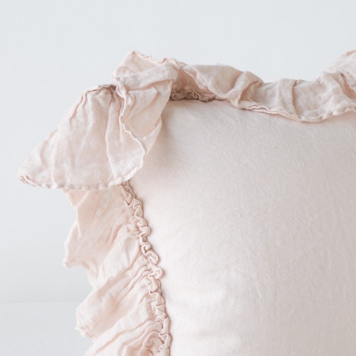 : Corner detail close-up of Linen Whisper sham, showcasing ruffle trim detail - pearl.