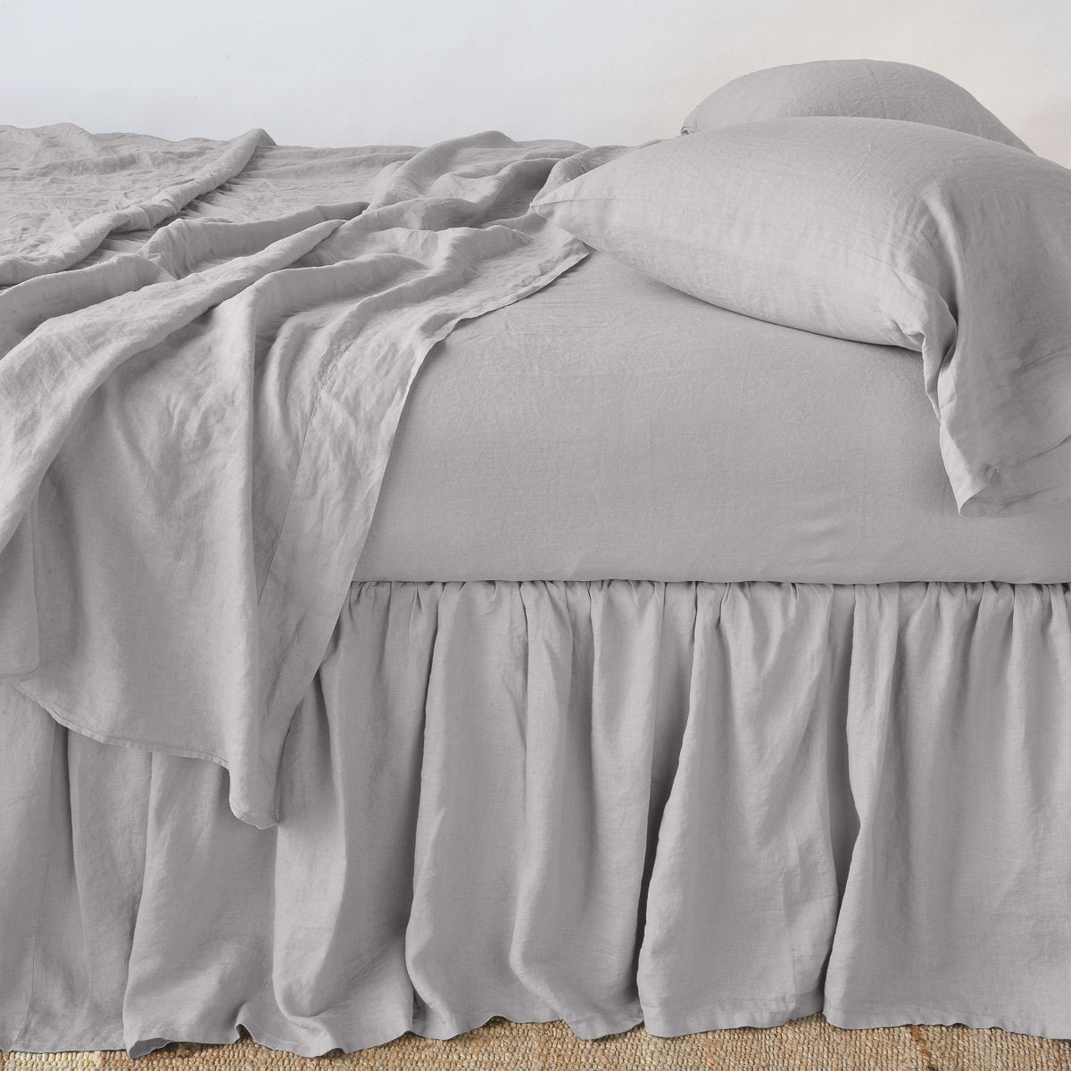 Fog: bed skirt with matching rumpled sheets and sleeping pillows - side view.