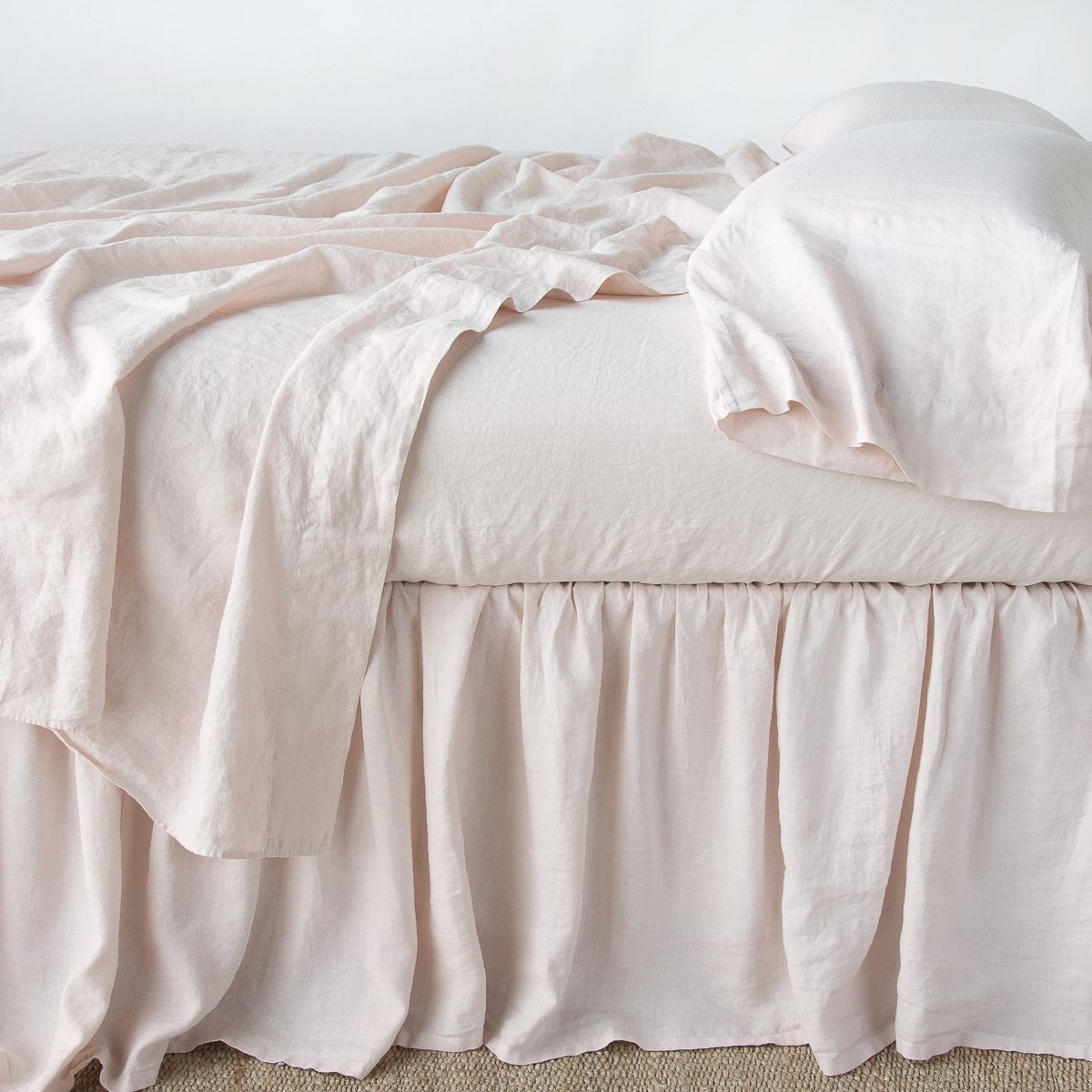 Pearl: bed skirt with matching rumpled sheets and sleeping pillows - side view.