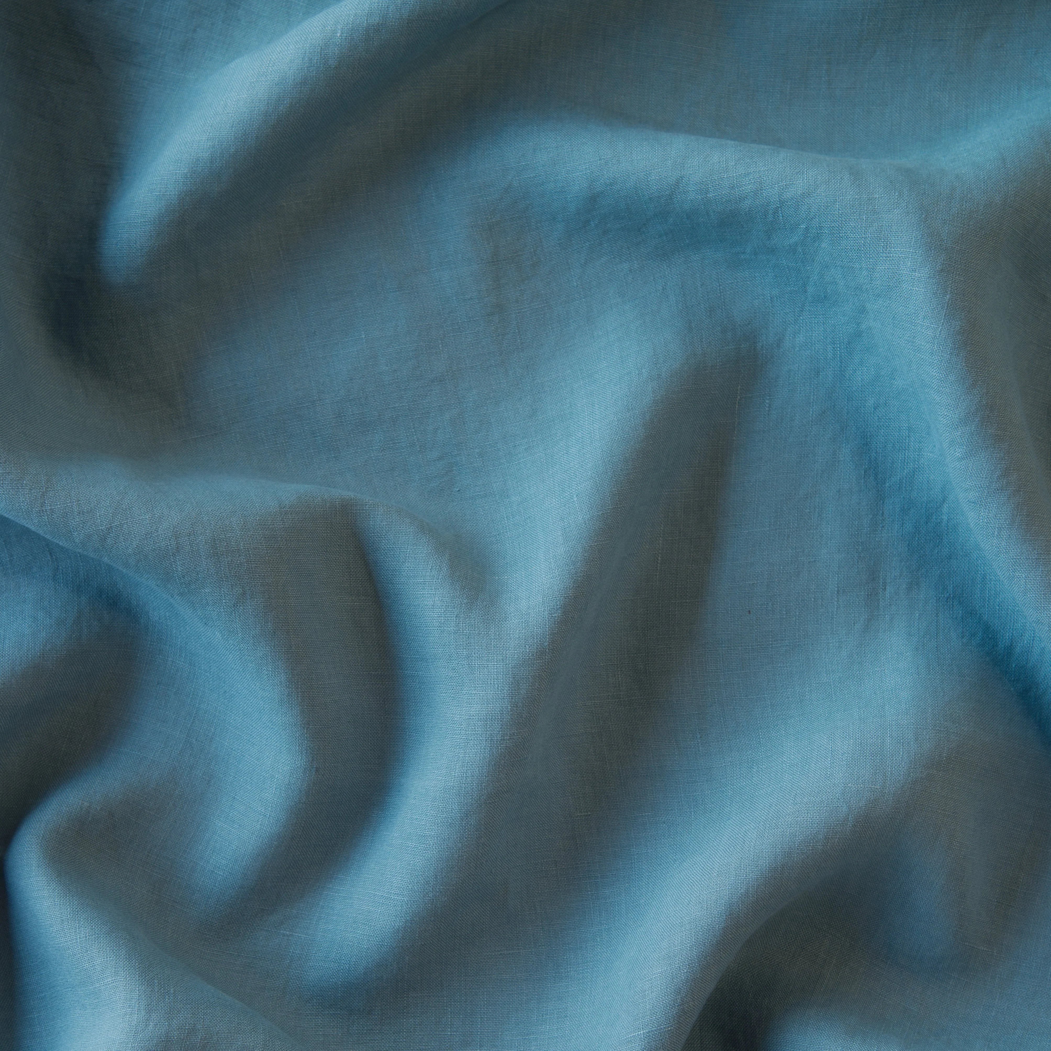 Cenote: A close up of linen in cenote, a vibrant, ocean-inspired blue-green.