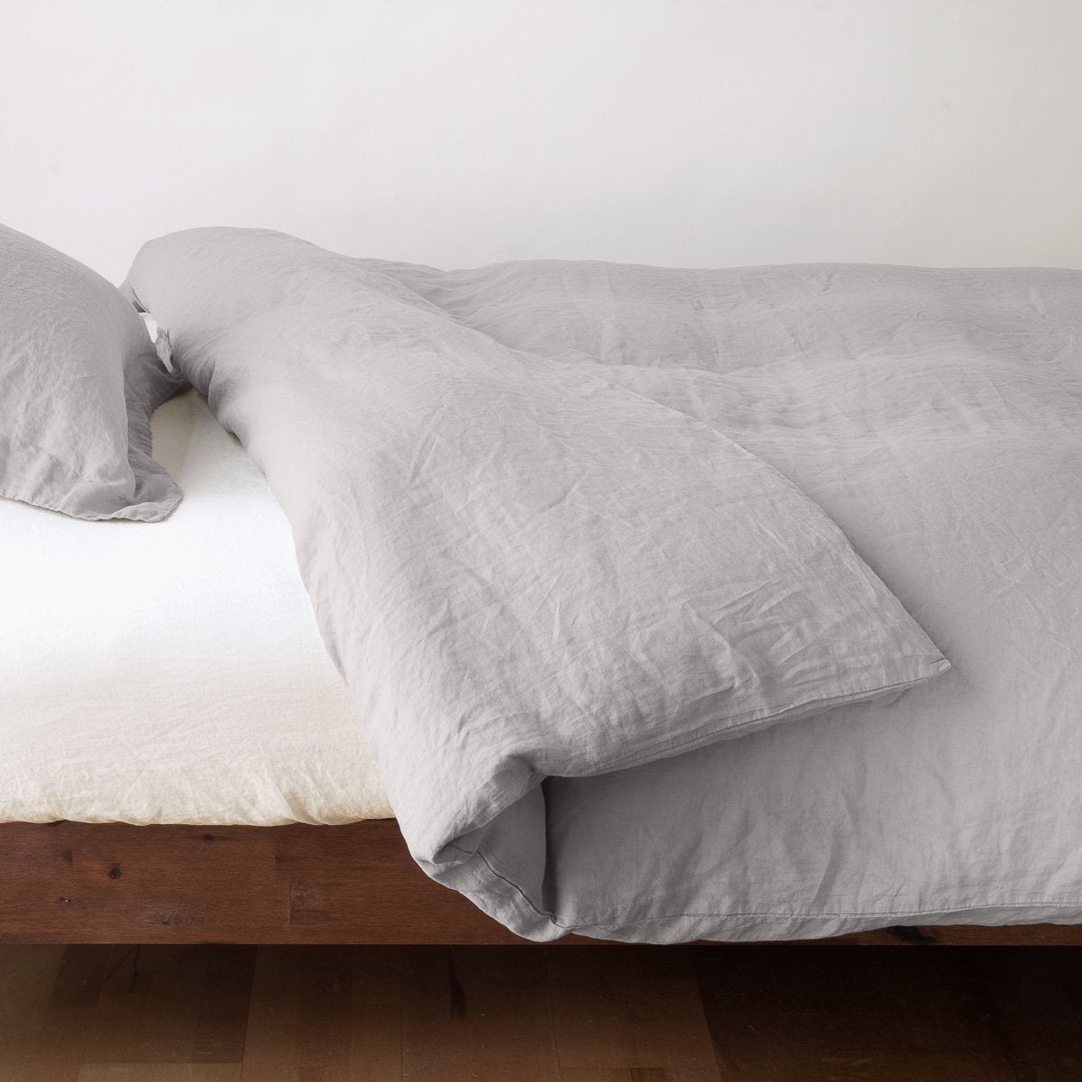 Fog: duvet cover neatly folded back over white linen sheeting - side view.