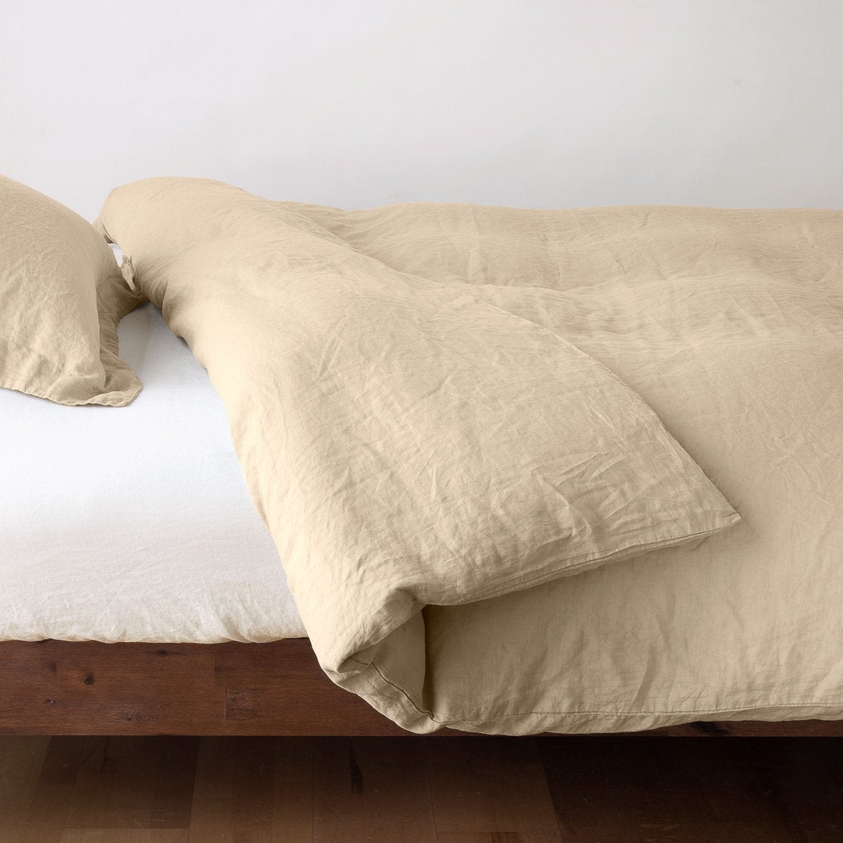 Honeycomb: duvet cover neatly folded back over white linen sheeting - side view.
