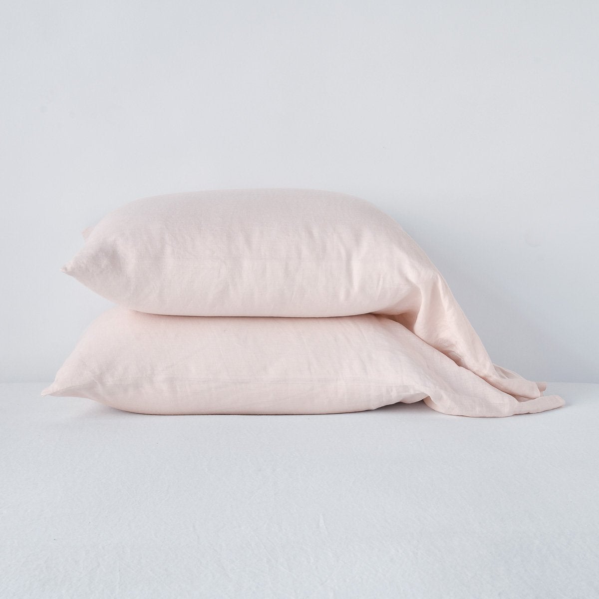 Pearl: Two sleeping pillows neatly stacked against a white background - side view.