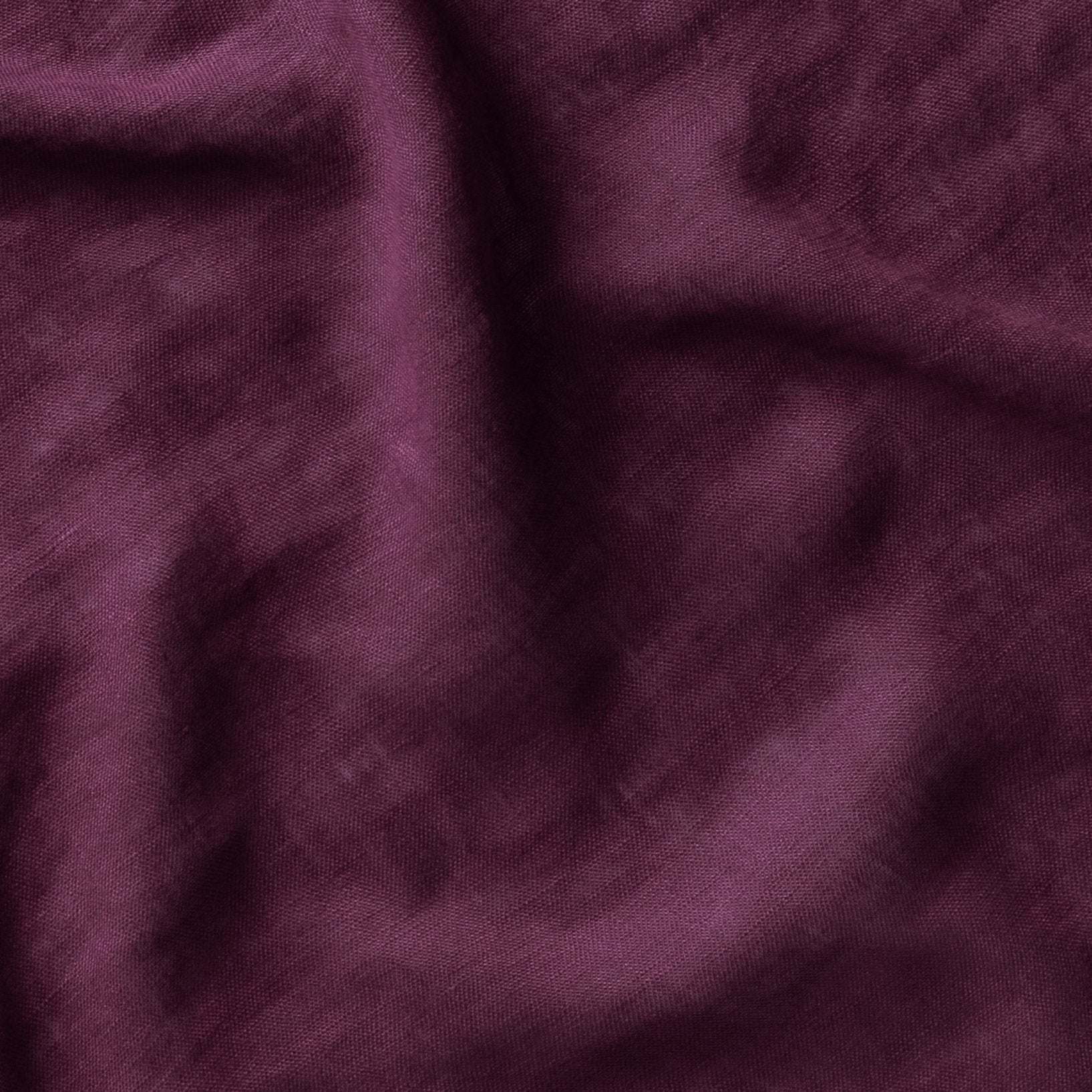 Fig: A close up of linen whisper, our lightweight linen gauze, in fig, a richly saturated purple-garnet. 