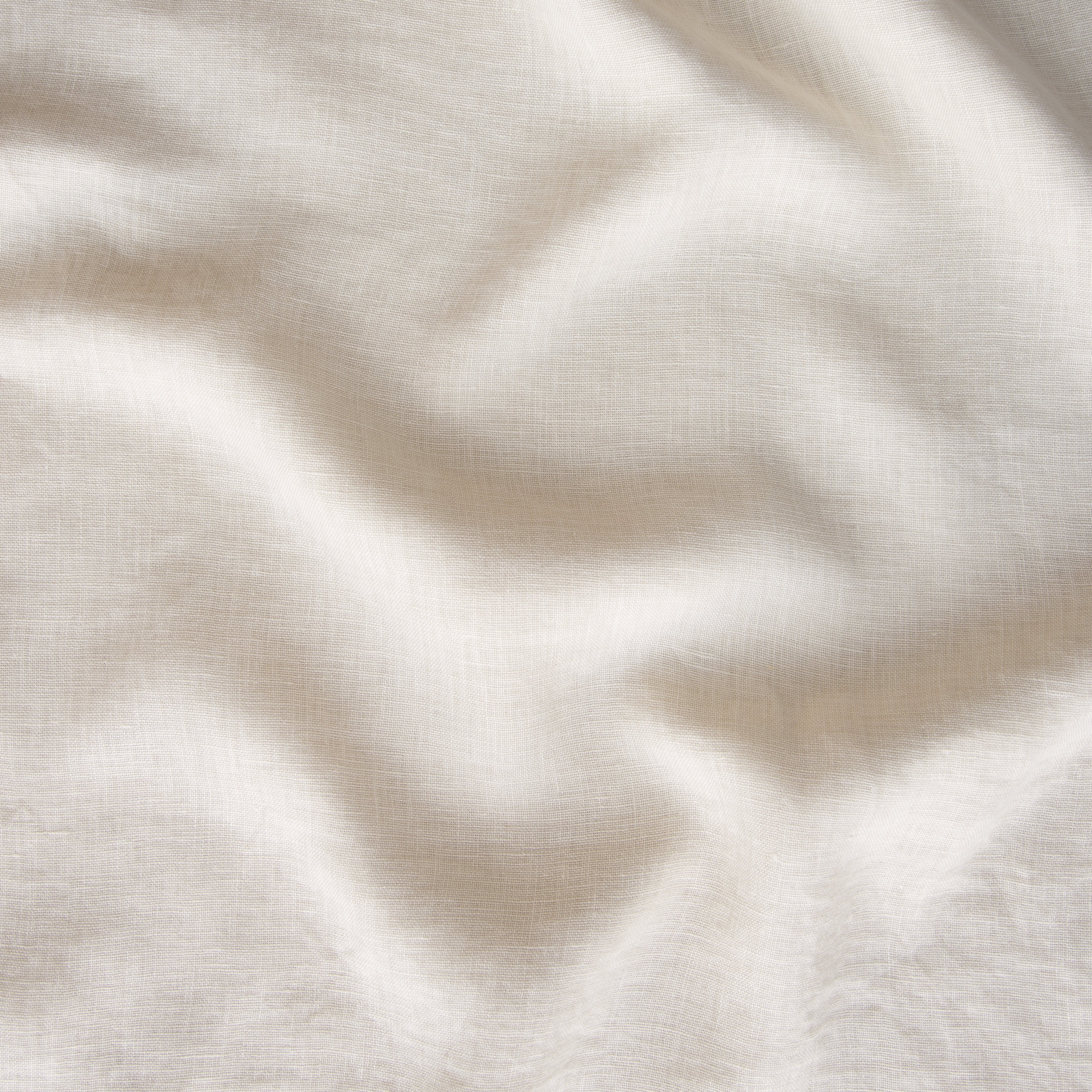 Parchment: A close up of linen whisper, our lightweight linen gauze, in parchment, a warm, antiqued cream.
