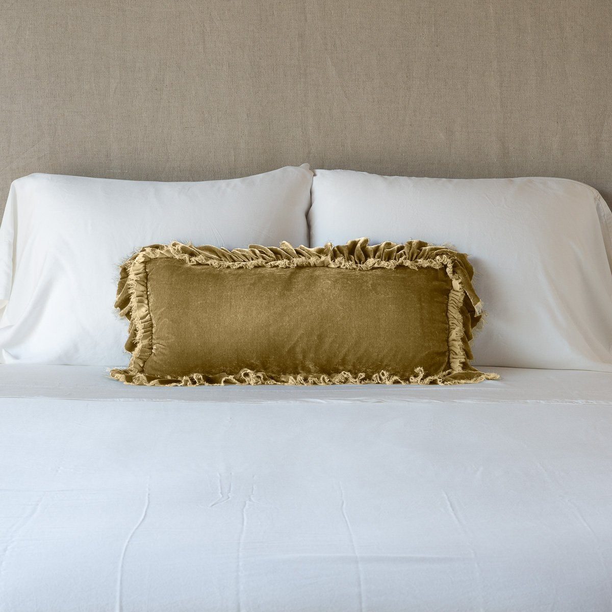 Honeycomb: pillow on a white bed - cropped end of bed view.