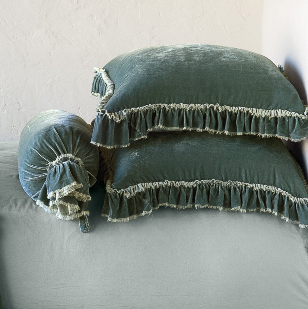 [allvariants]: Two Loulah shams laying flat, stacked on a bed with matching bolster and on-tone sheets - eucalyptus. Close-up side view highlights the ruffle trim.