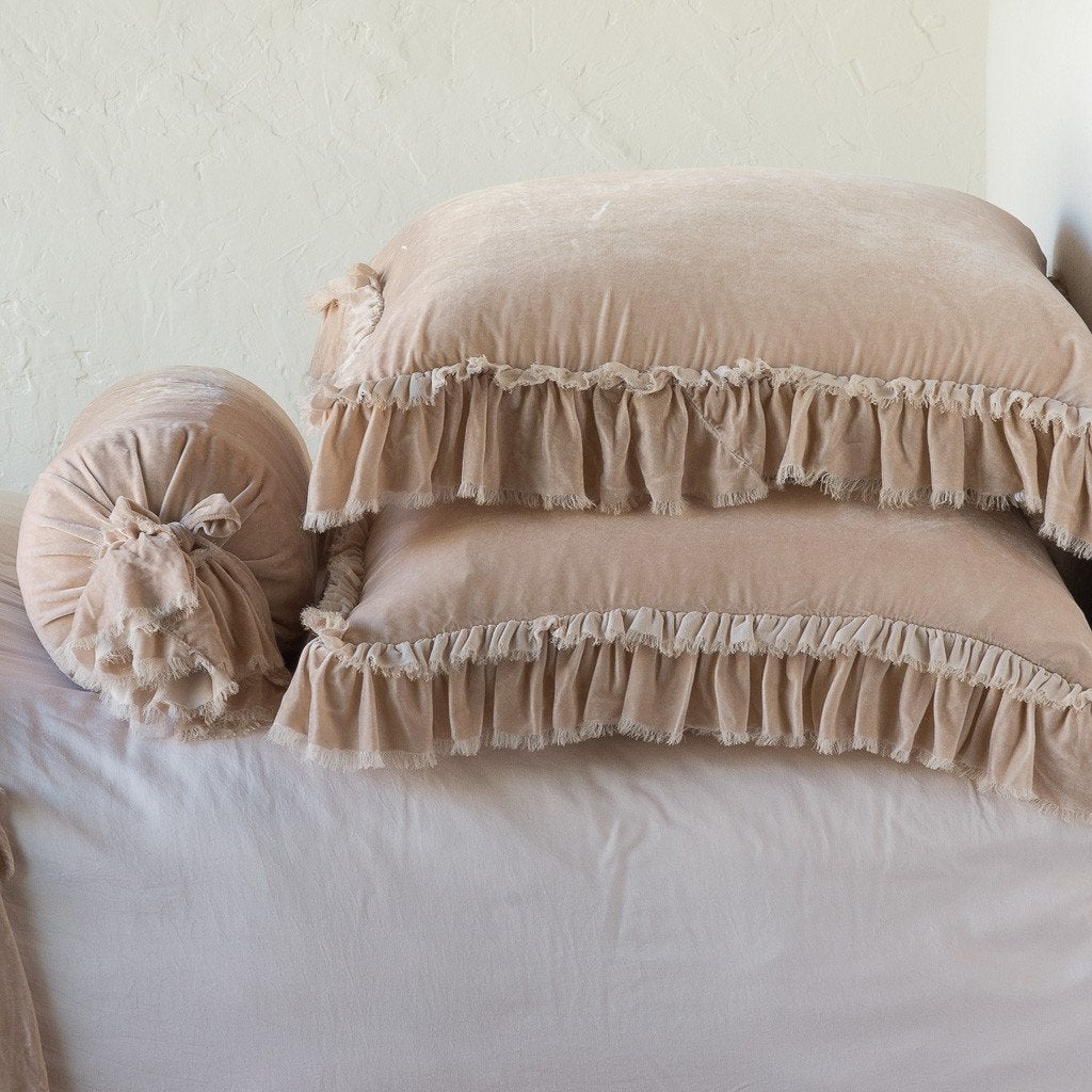 Pearl: Two shams stacked flat next to matching bolster. Close-up side view highlights the ruffle trim.