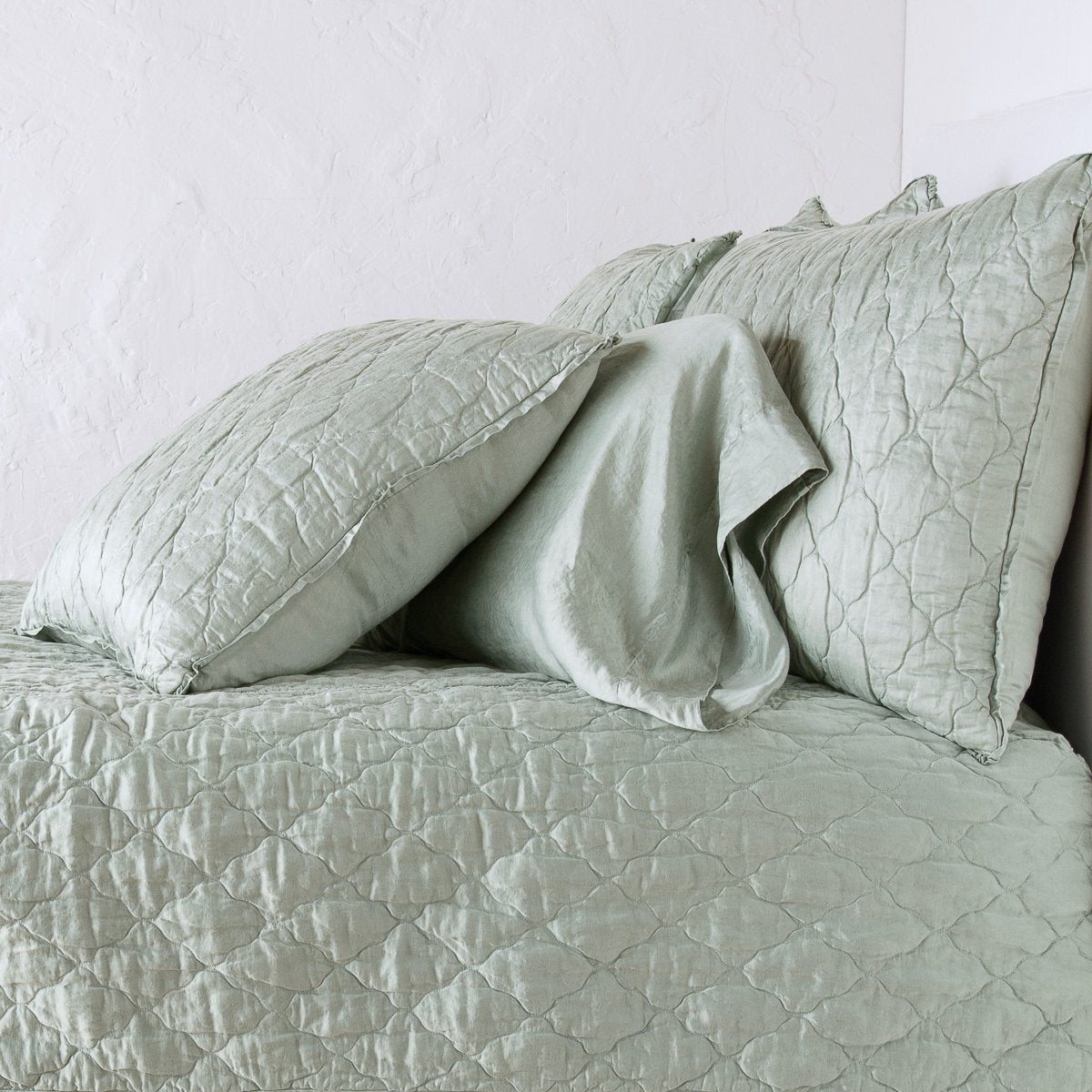: Luna shama with a matching coverlet and silk charmeuse sleeping pillow - eucalyptus, side view.