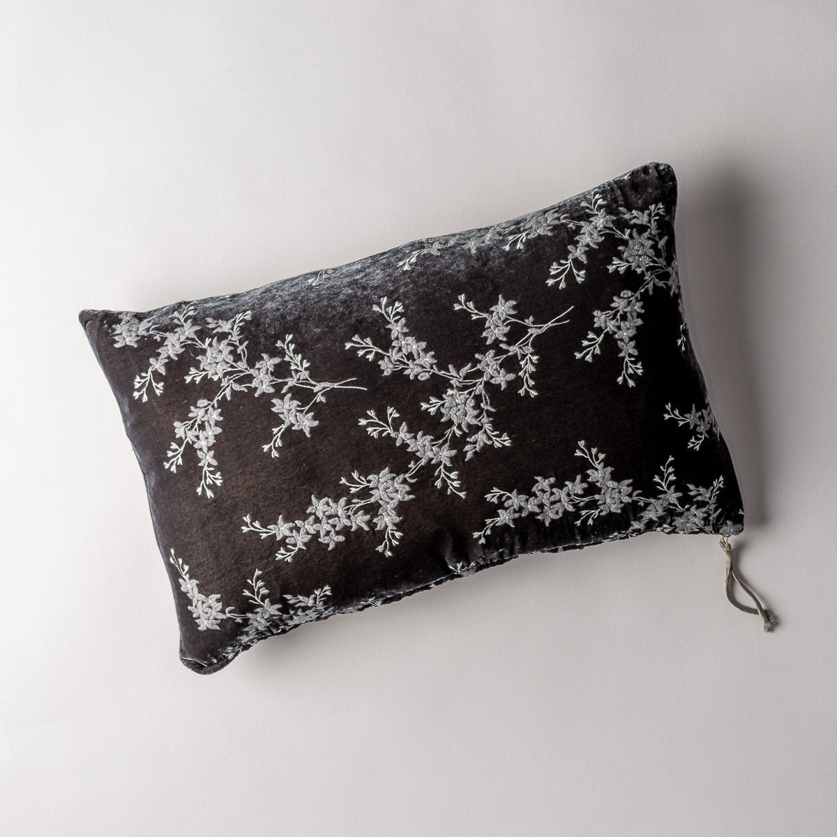 Moonlight: overhead of 15x24 embroidered silk velvet pillow against a white background