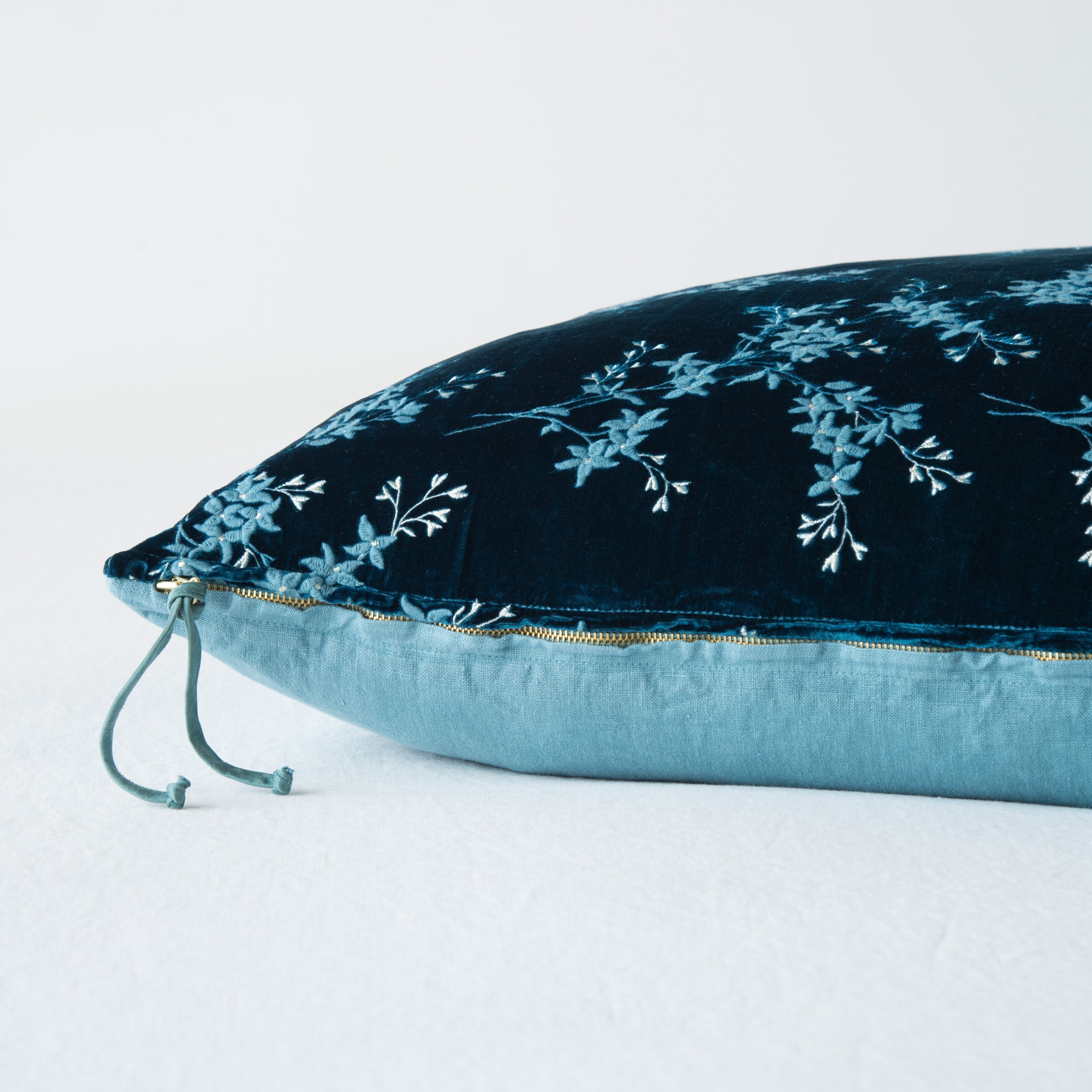 Cenote: Close-up side vew featuring brass zipper with charmeuse pull, and linen back.