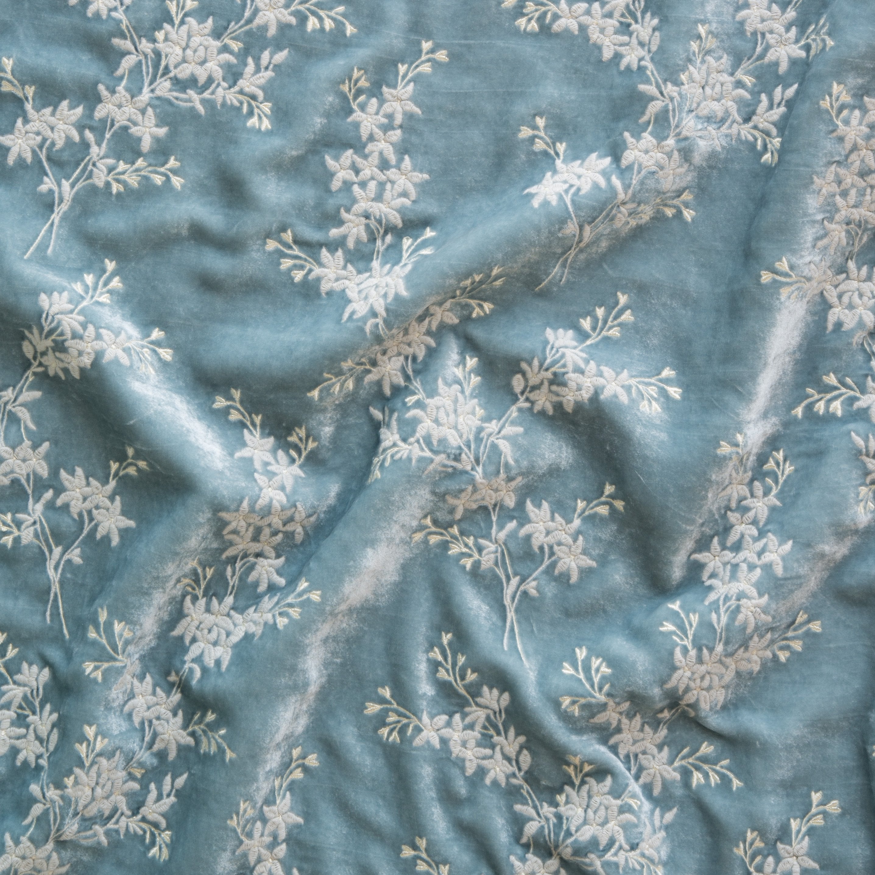 Cloud: A close up of Lynette embroidered silk velvet, in cloud, a soft, subtle sky blue-grey. 