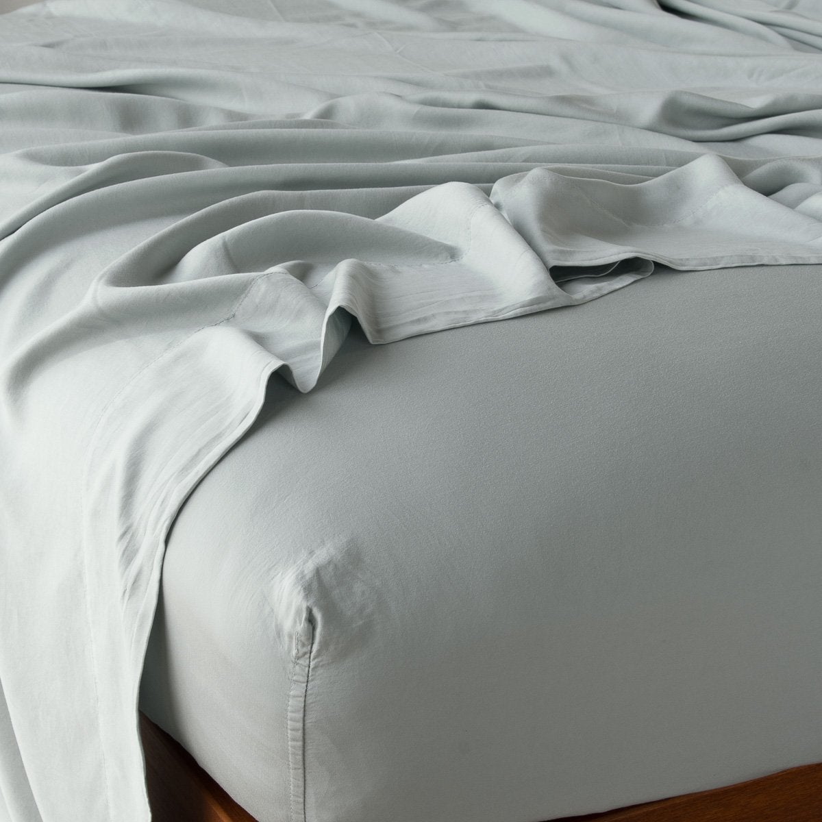 Eucalyptus: fitted sheet with matching rumpled flat sheet - top corner view.