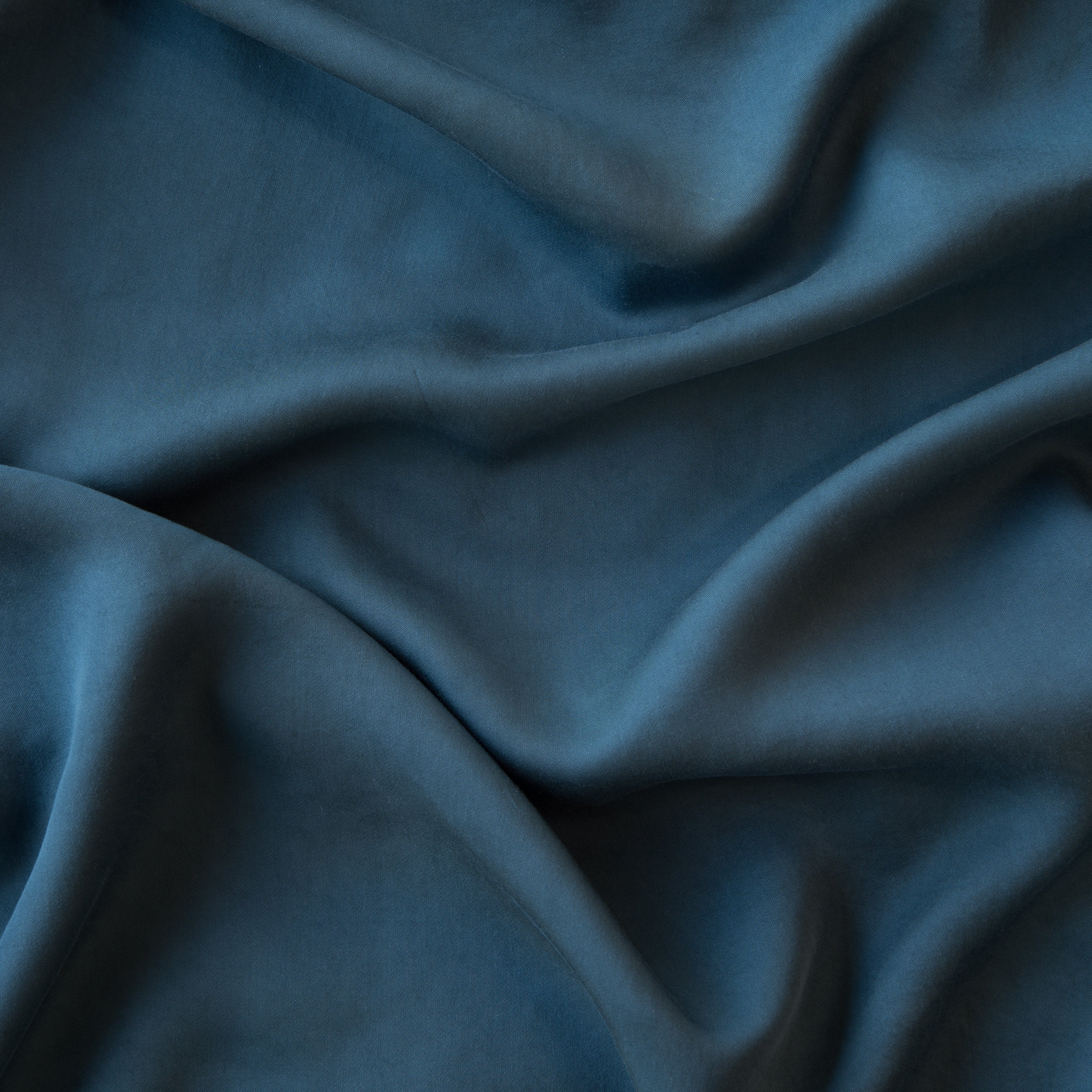 Midnight: A close up of Tencel™ fabric in midnight, a rich indigo tone. 
