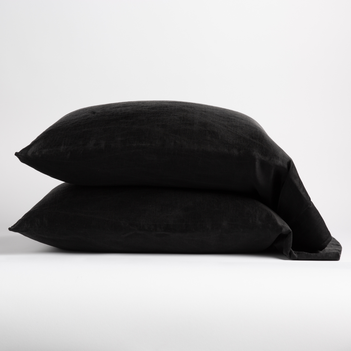Corvino: two sleeping pillows neatly stacked on white background. 