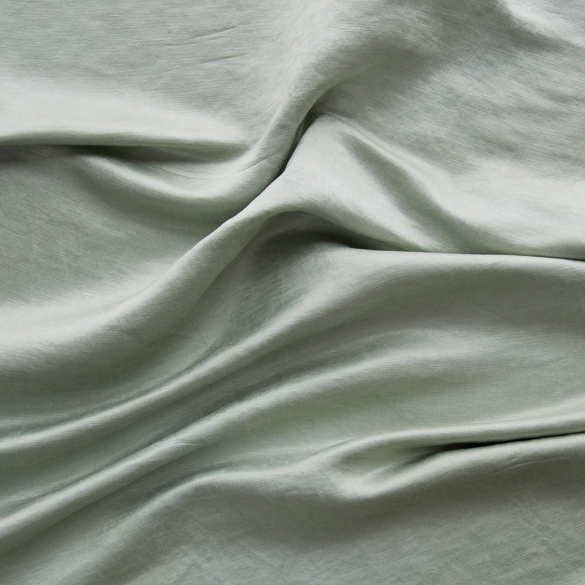 Eucalyptus: Close-up of silk charmeuse in eucalyptus, a soft, light green. 