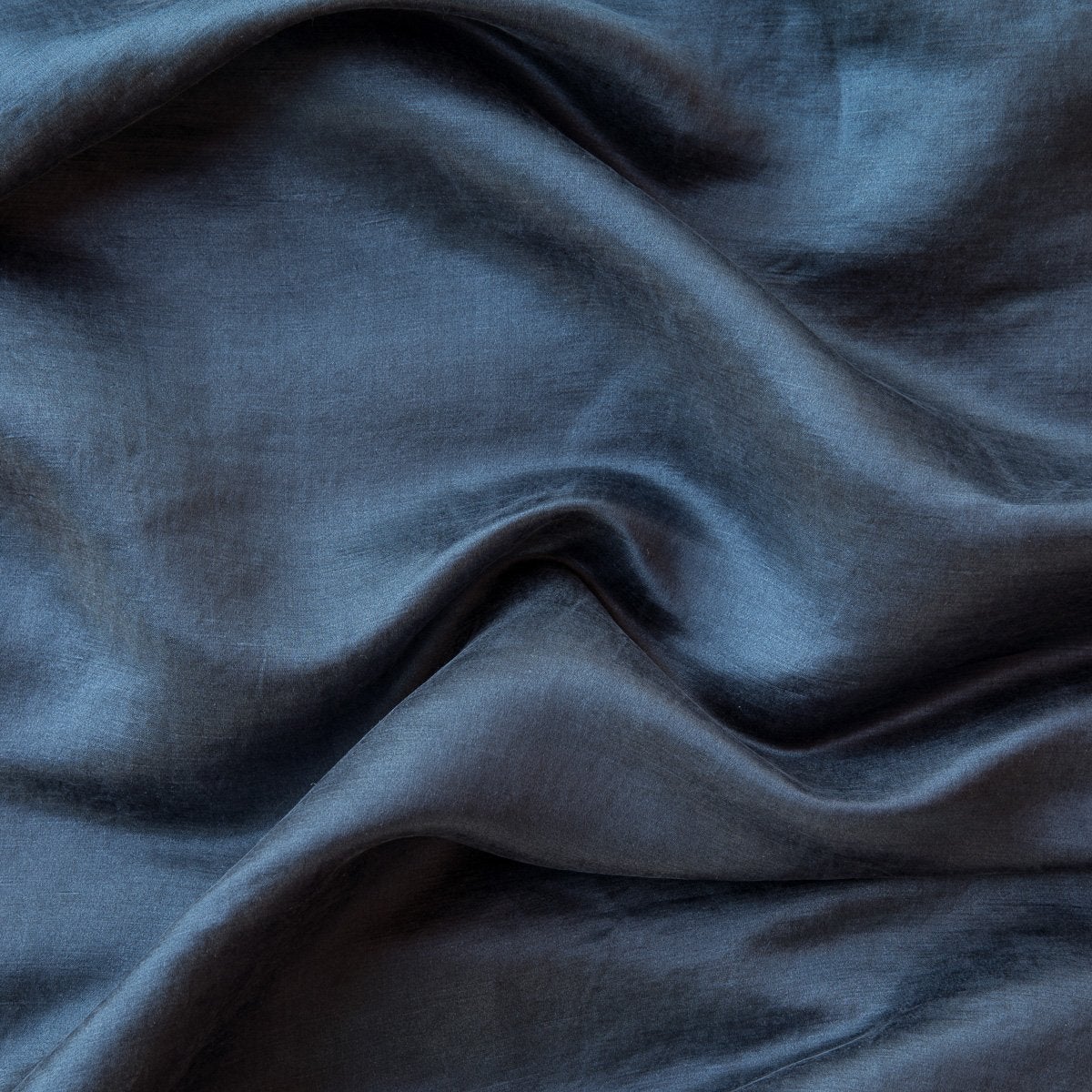 Midnight: Close-up of silk charmeuse in midnight, a rich indigo tone. 