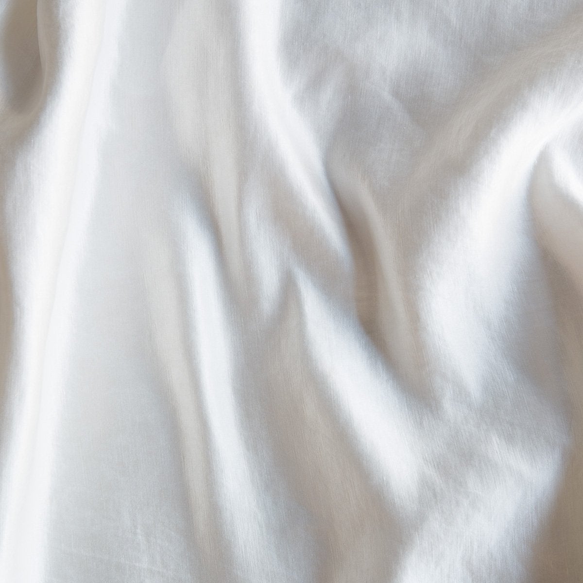 Winter White: Close-up of silk charmeuse in winter white, softer and warmer in tone than classic white.