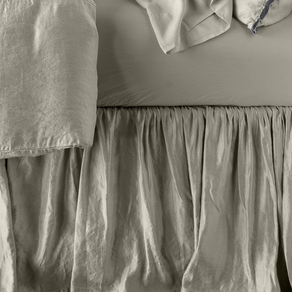 [allvariants]: Close up of Paloma bed skirt, highlighting the shimmering fabric and the gathering detail - fog, side view.
