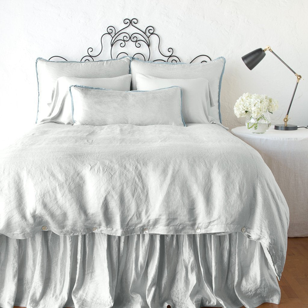 Cloud: duvet cover with matching pillows and bed skirt - end of bed view.