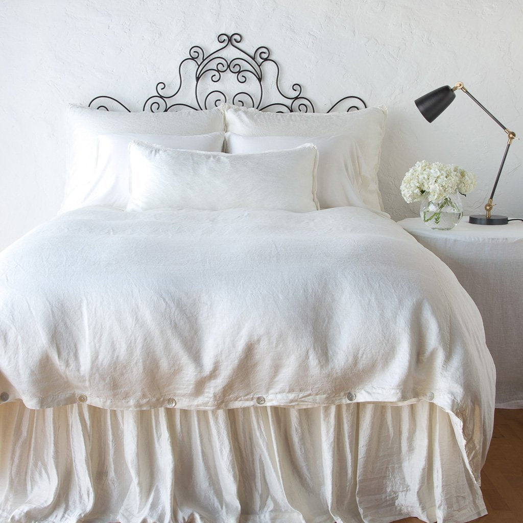 [allvariants]: Paloma duvet cover with matching pillows and bed skirt - winter white, end of bed view.
