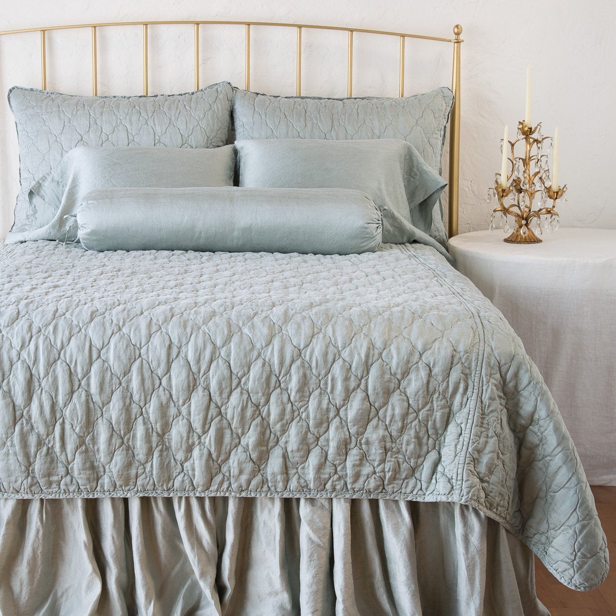 : Paloma sleeping pillows on a monochromatic, all-charmeuse bed - mineral, end of bed view.