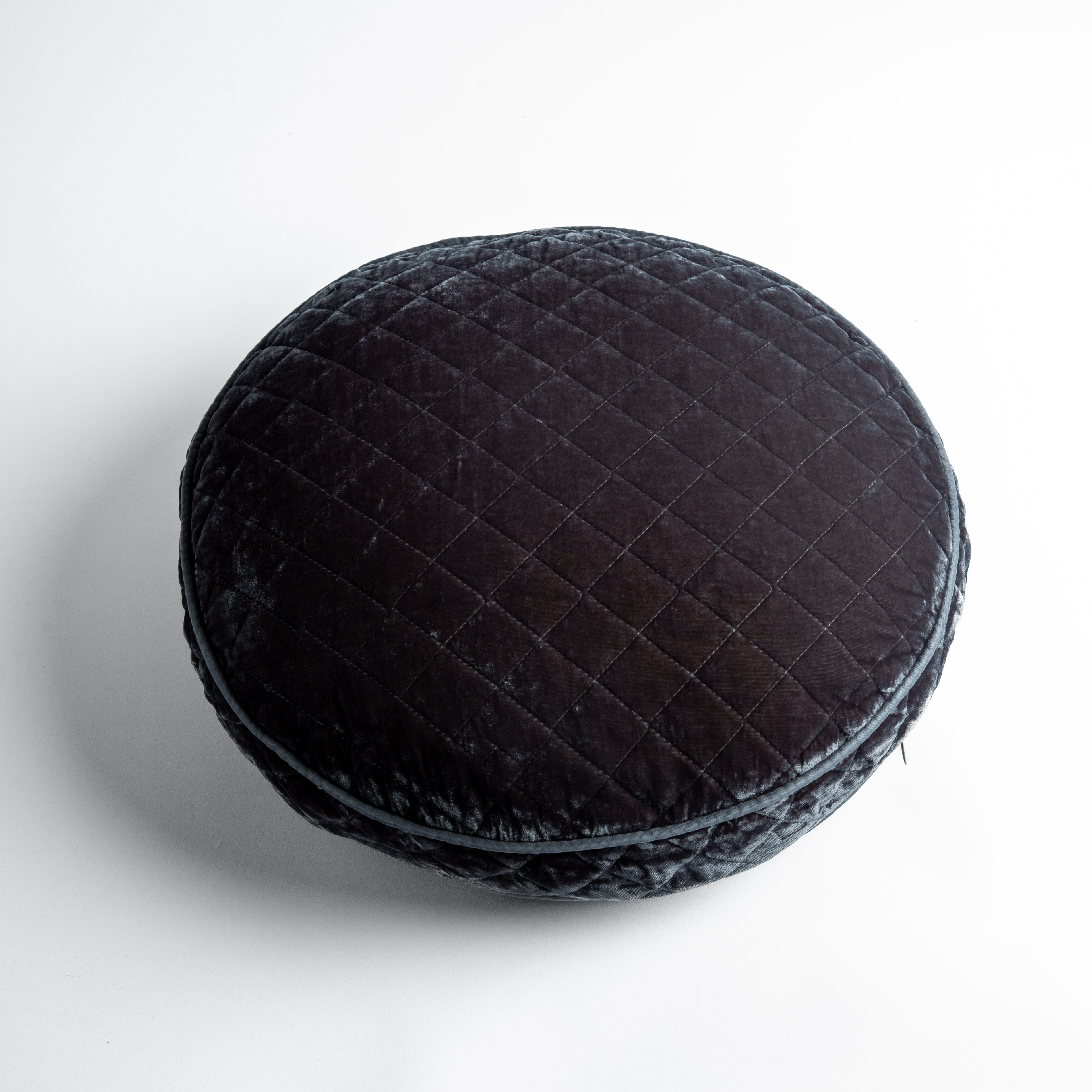 Moonlight: overhead at a slight angle against a white background, the face and gusset of the pillow are visible.