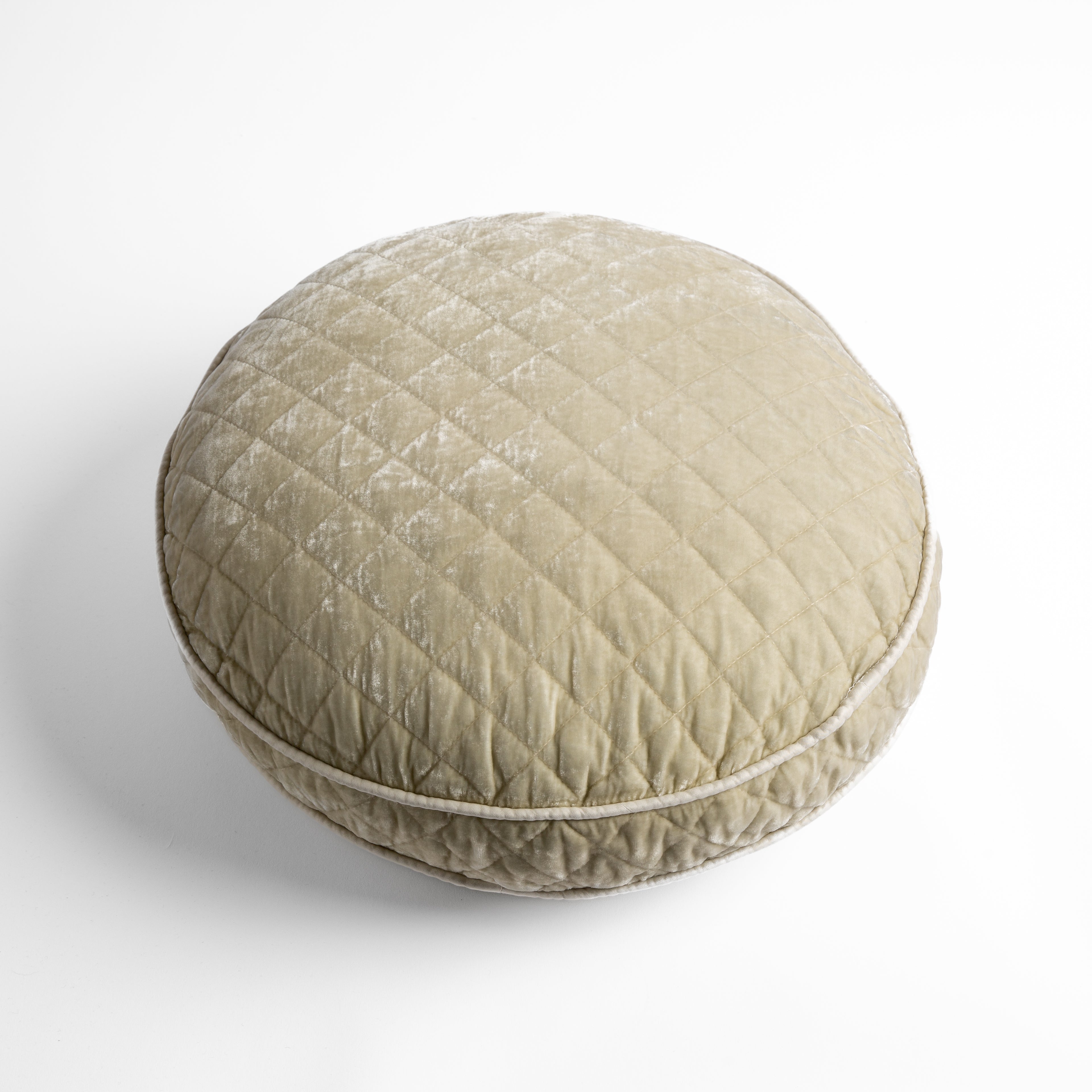 Parchment: overhead at a slight angle against a white background, the face and gusset of the pillow are visible. 