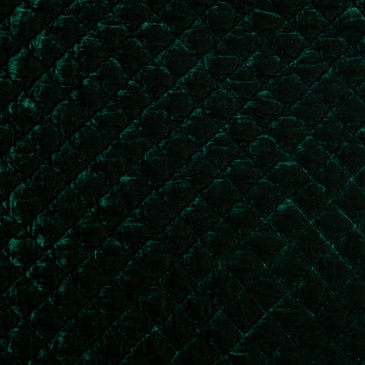 Jade: Close-up of quilted silk velvet in jade, a rich, verdant green with subtle blue undertones. 