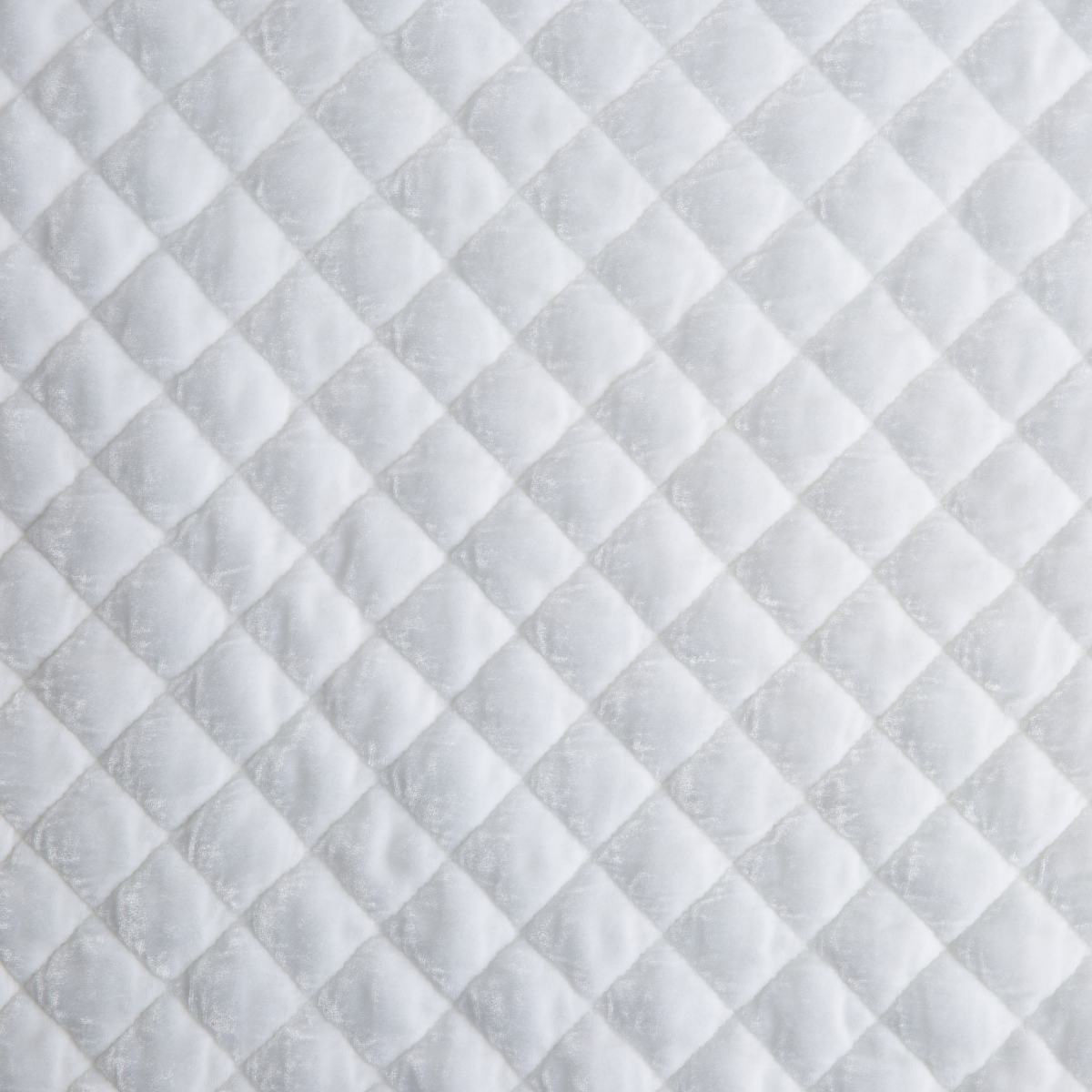 White: Close-up of quilted silk velvet in white.