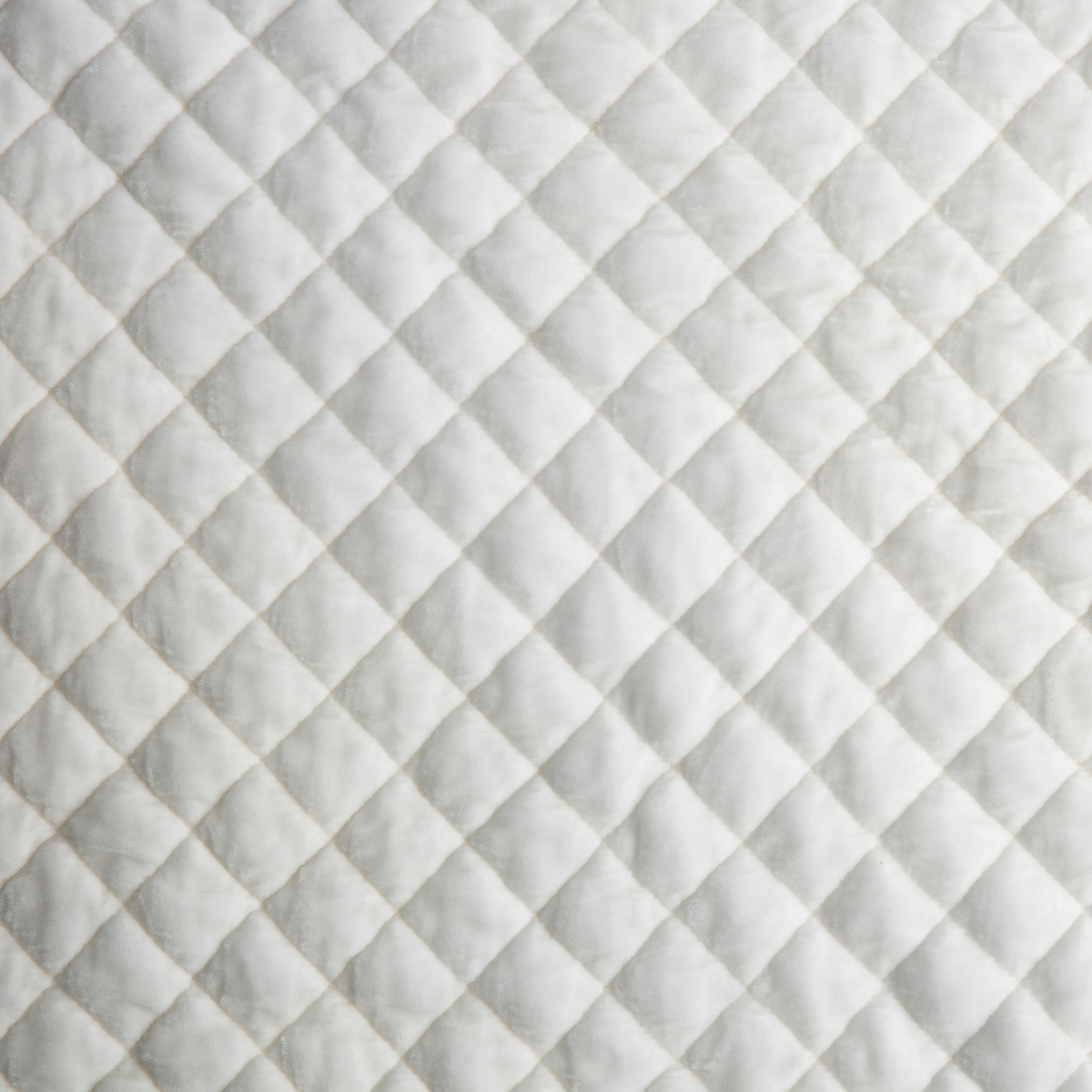 Winter White: Close-up of quilted silk velvet in winter white, softer and warmer in tone than classic white.