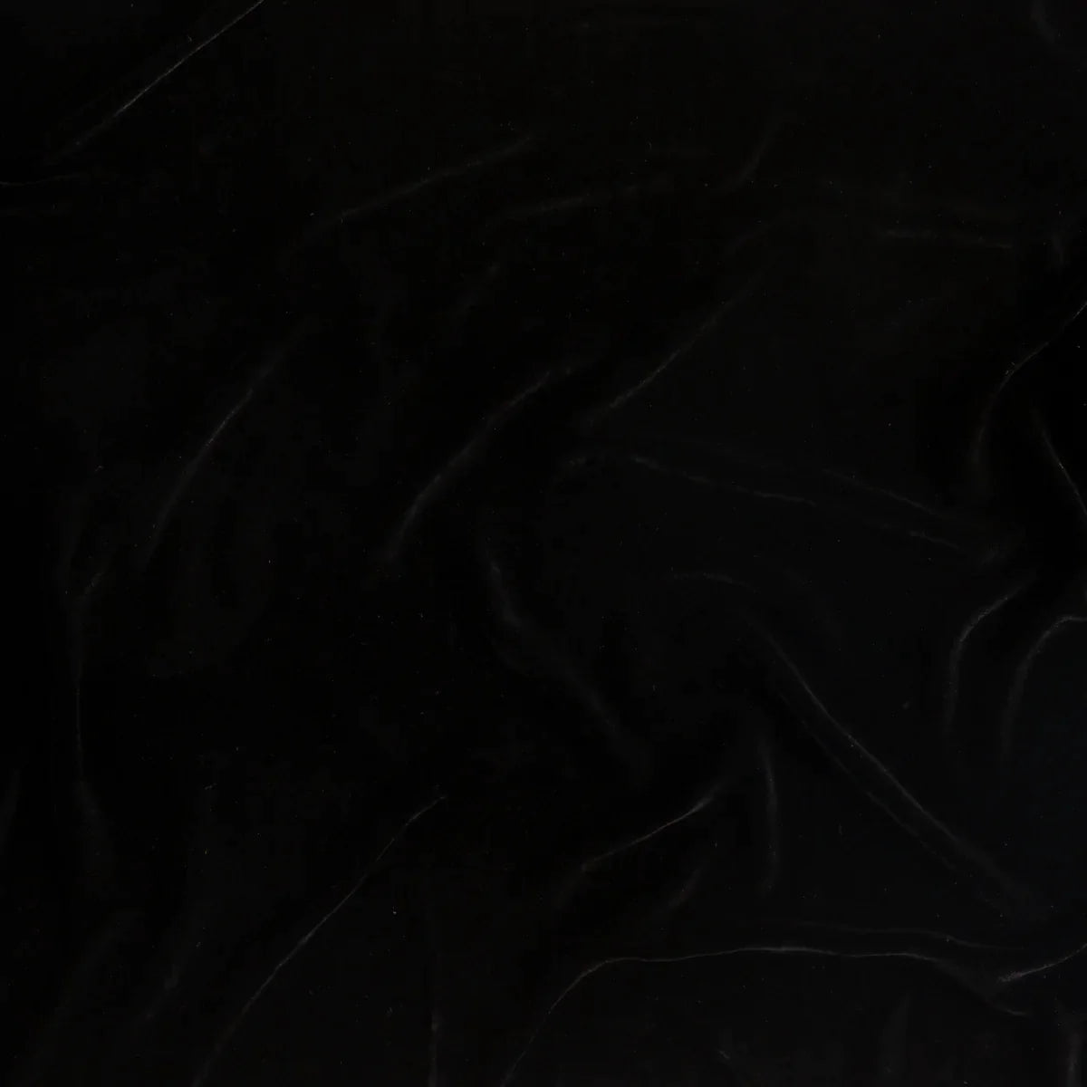 Corvino: A close up of silk velvet fabric in Corvino, a black tone