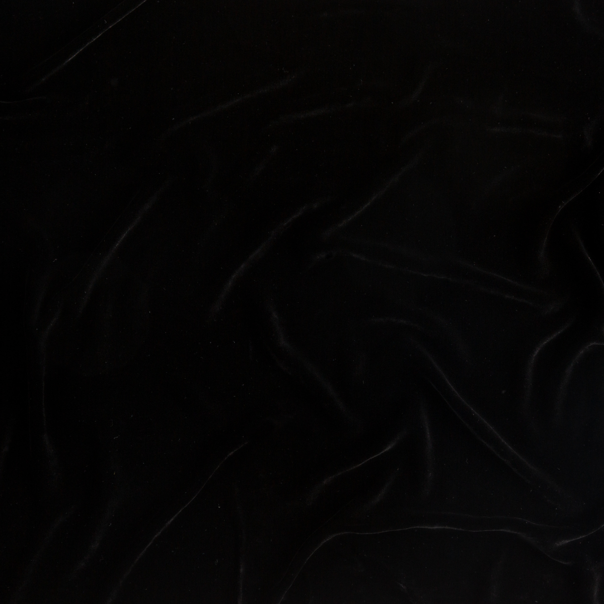 Corvino: A close up of silk velvet fabric in Corvino, a black tone