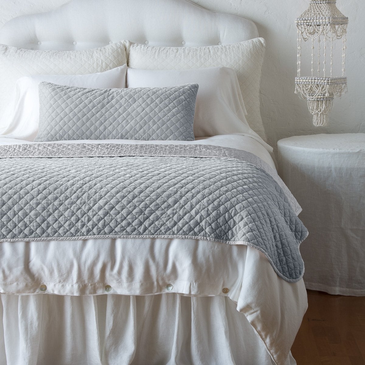 [allvariants]: Silk velvet throw blanket and matching lumbar pillow on a neatly made white bed - cloud, end of bed view.