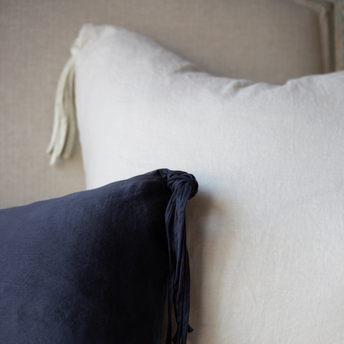 : Close-up of Taline 24 by 24 pillows, highlighting that this collection is reversible with a midweight linen back.