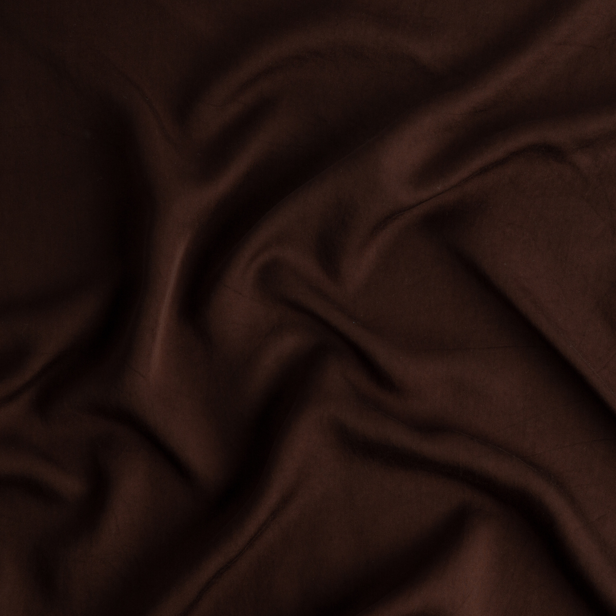 Mahogany: A close up of Tencel™ fabric in mahogany, a deep, earthen, reddish brown.