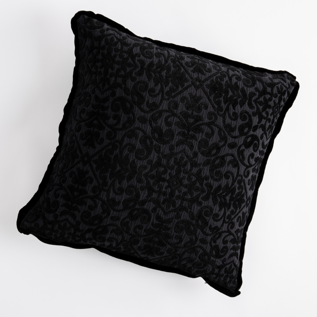 Corvino: cotton chenille jacquard 18x18 pillow shown from overhead to display the pillow's face and silk velvet trim — overhead against a white background.